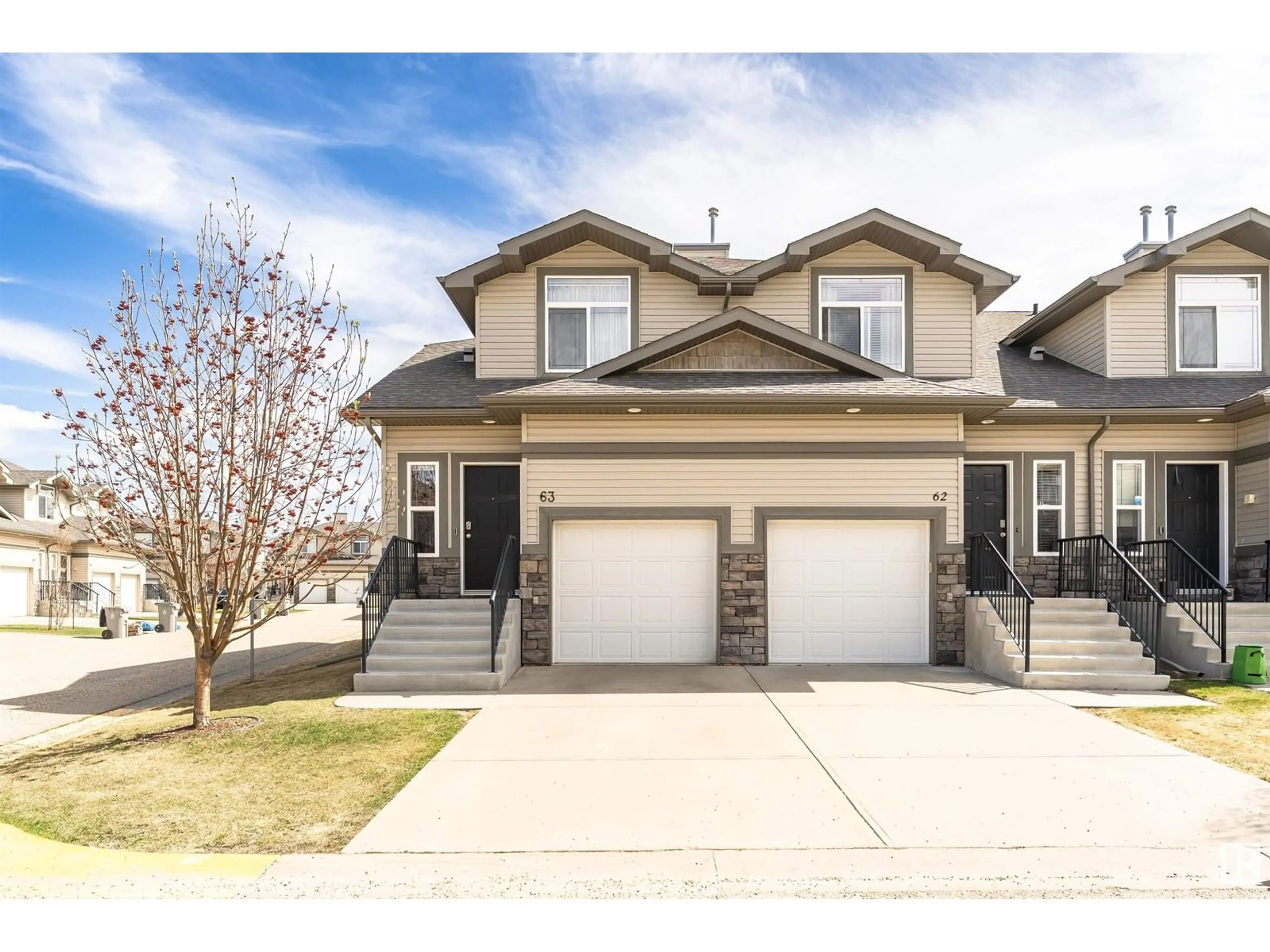 Home with vinyl exterior material, street for 63 9511 102 AV, Morinville Alberta T8R0C6