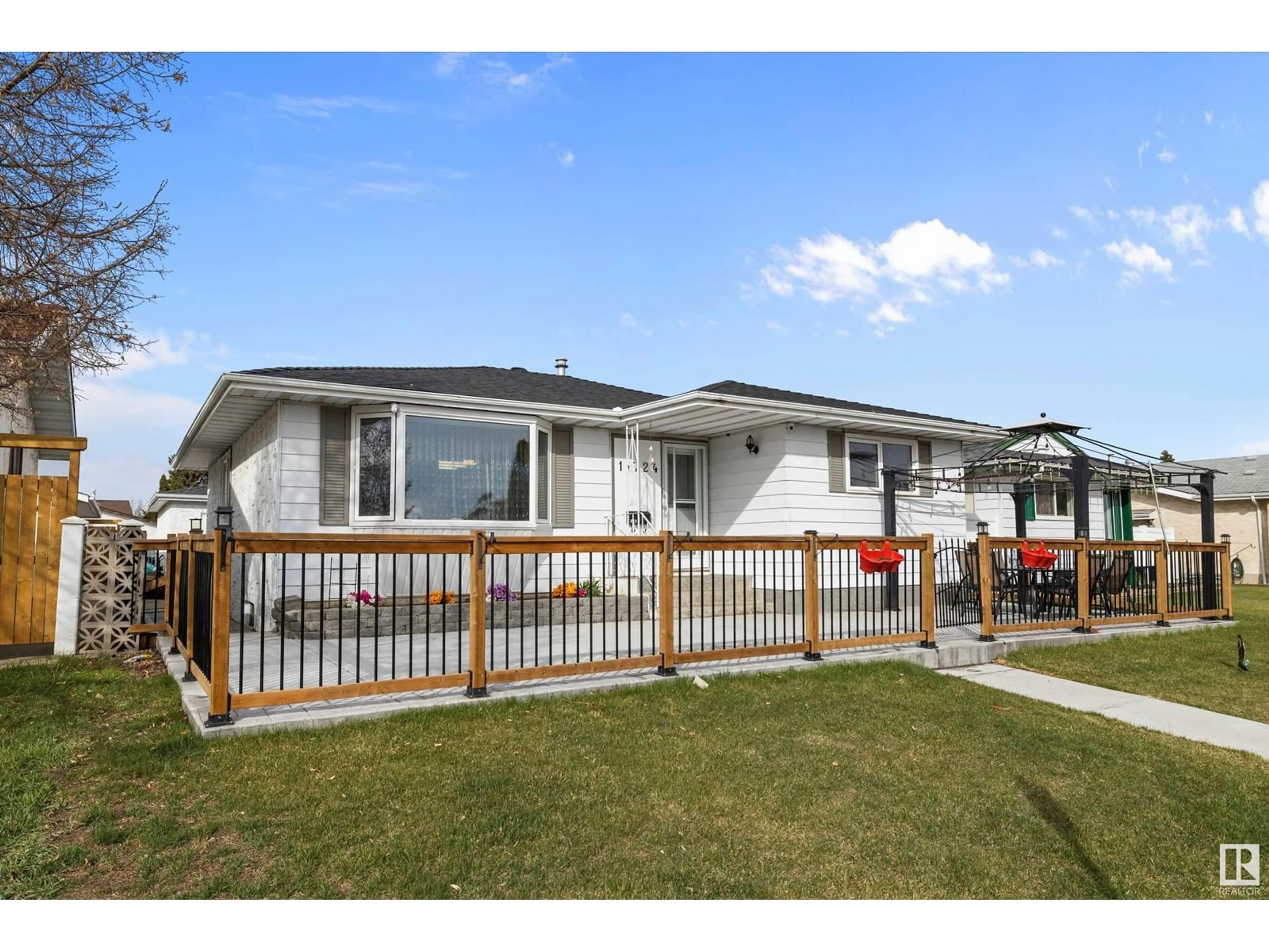 Home with vinyl exterior material, street for 11724 152 AV, Edmonton Alberta T5X1S8