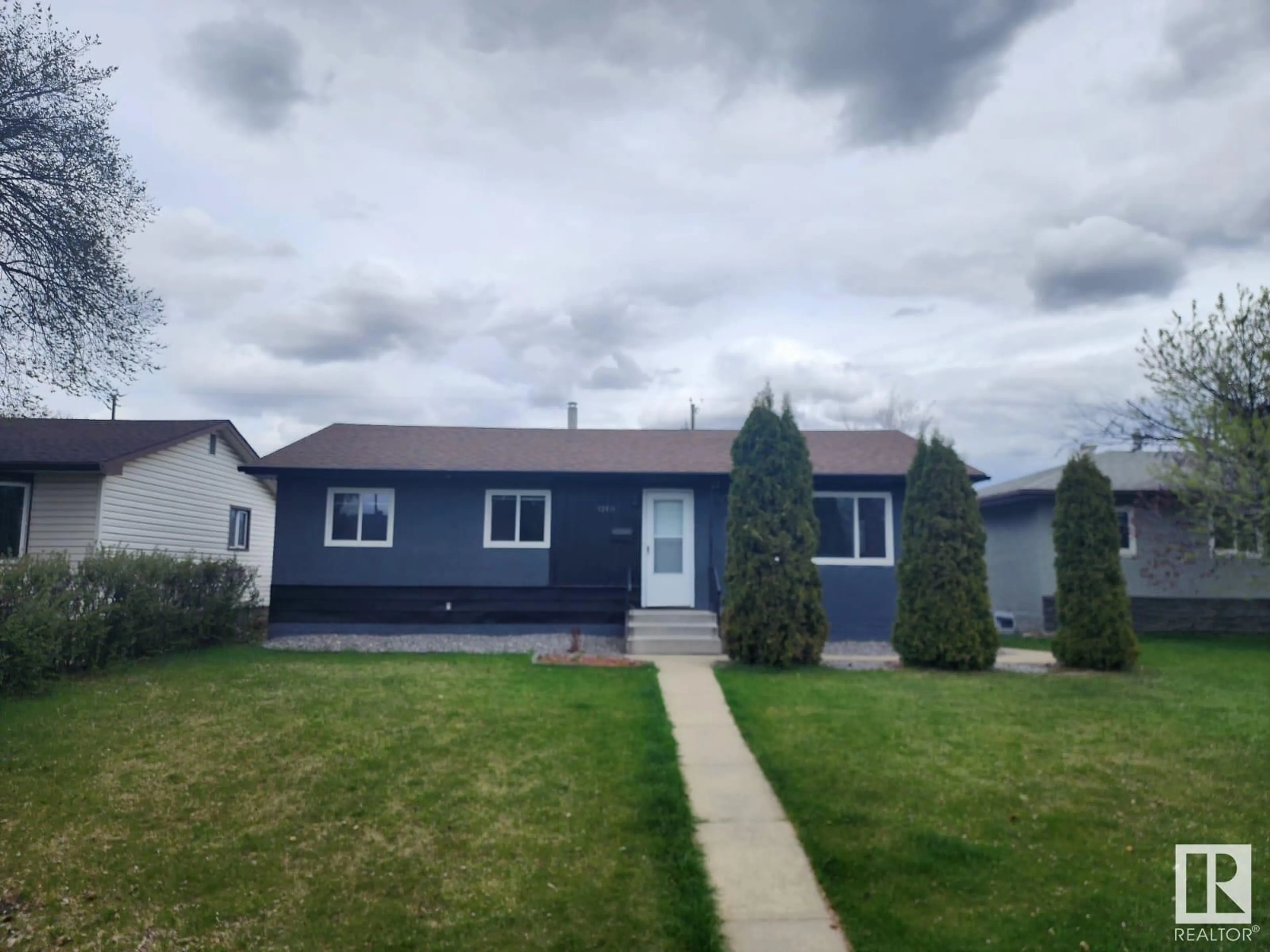 Home with vinyl exterior material, street for 12416 136 AV, Edmonton Alberta T5L4A8
