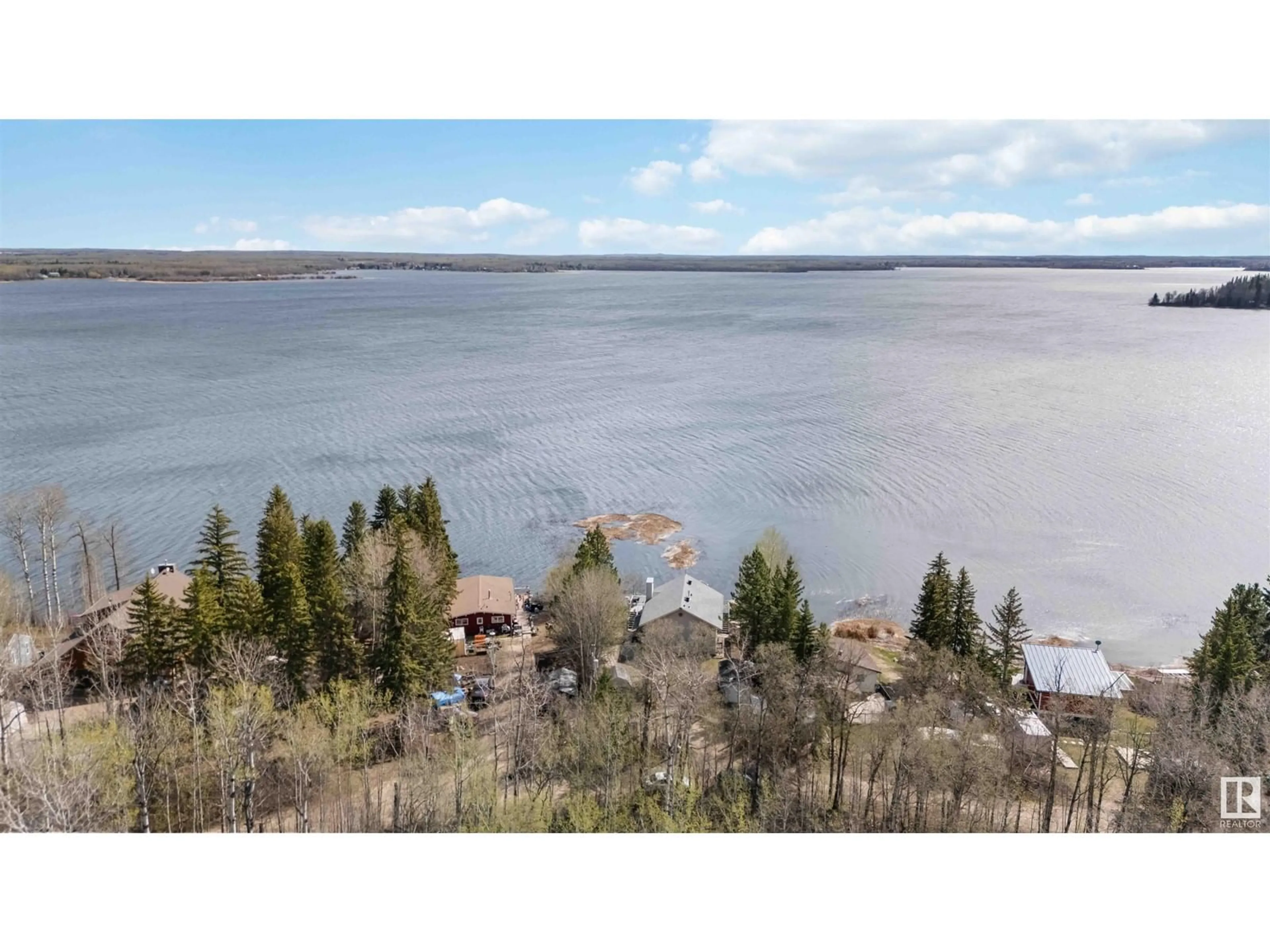 A pic from outside/outdoor area/front of a property/back of a property/a pic from drone, water/lake/river/ocean view for 129 - 3215 TWP RD 574, Rural Lac Ste. Anne County Alberta T0E1A0