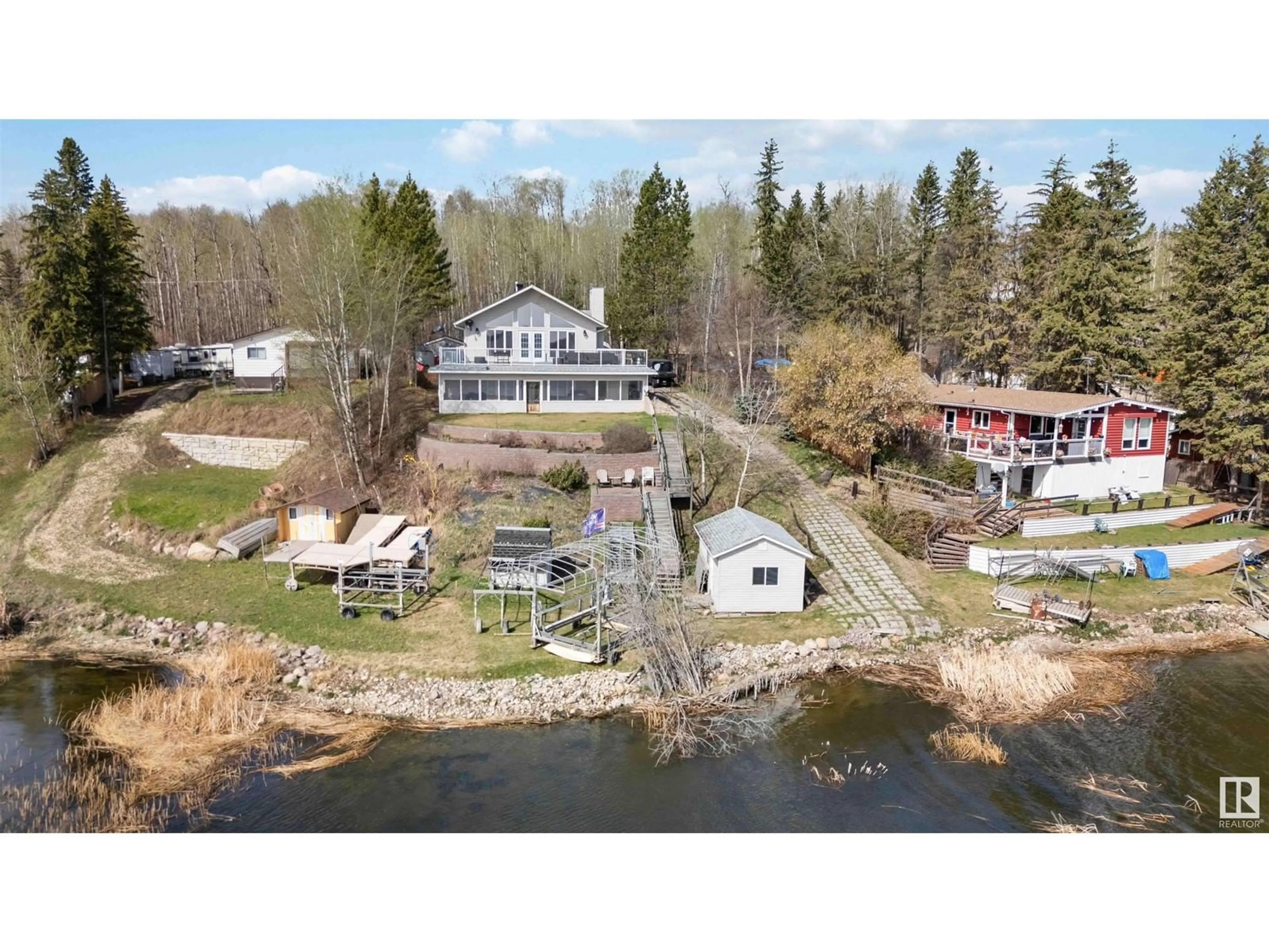 A pic from outside/outdoor area/front of a property/back of a property/a pic from drone, water/lake/river/ocean view for 129 - 3215 TWP RD 574, Rural Lac Ste. Anne County Alberta T0E1A0