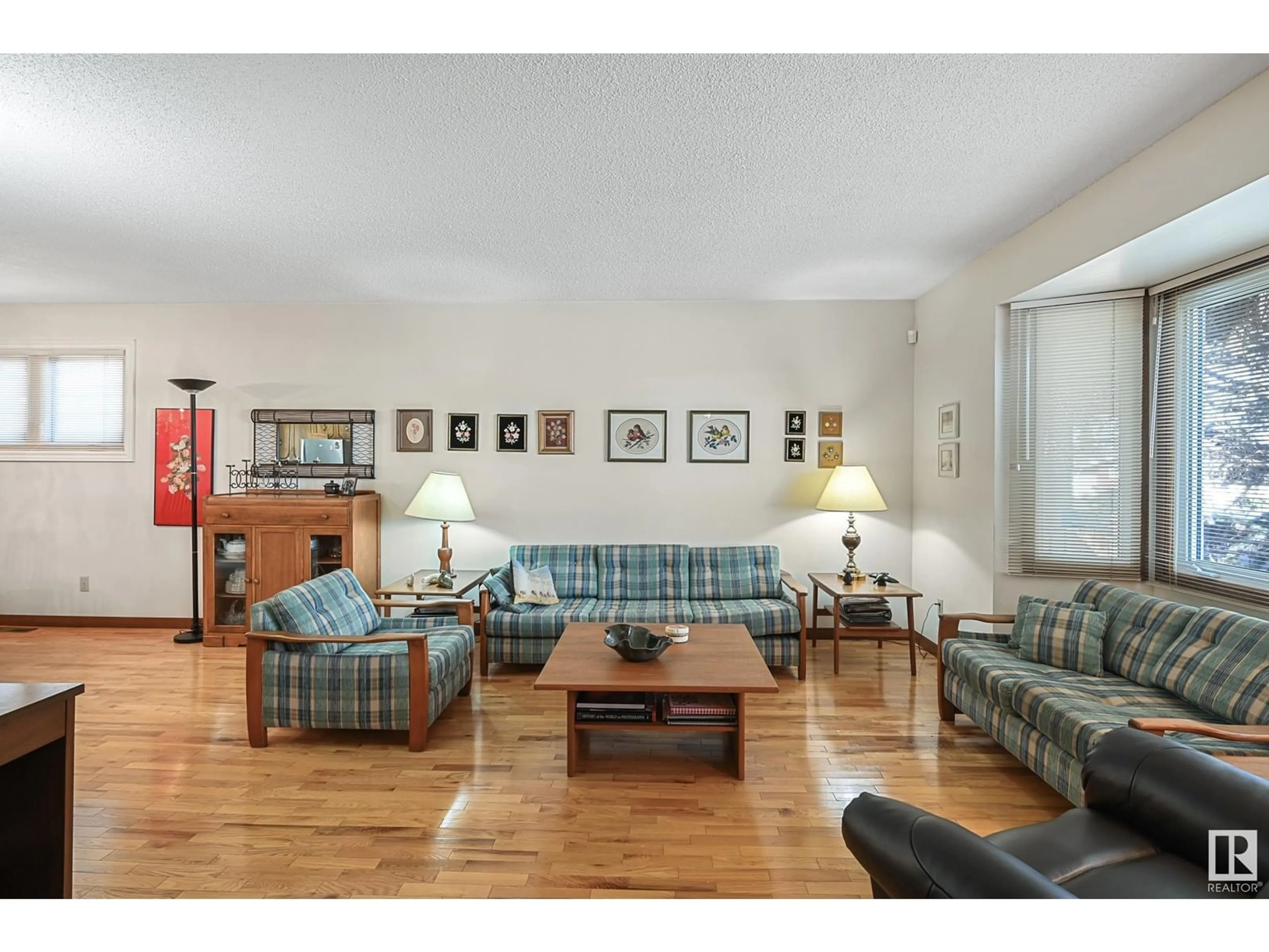 Living room with furniture, wood/laminate floor for 8107 44 AV, Edmonton Alberta T6K0Z3