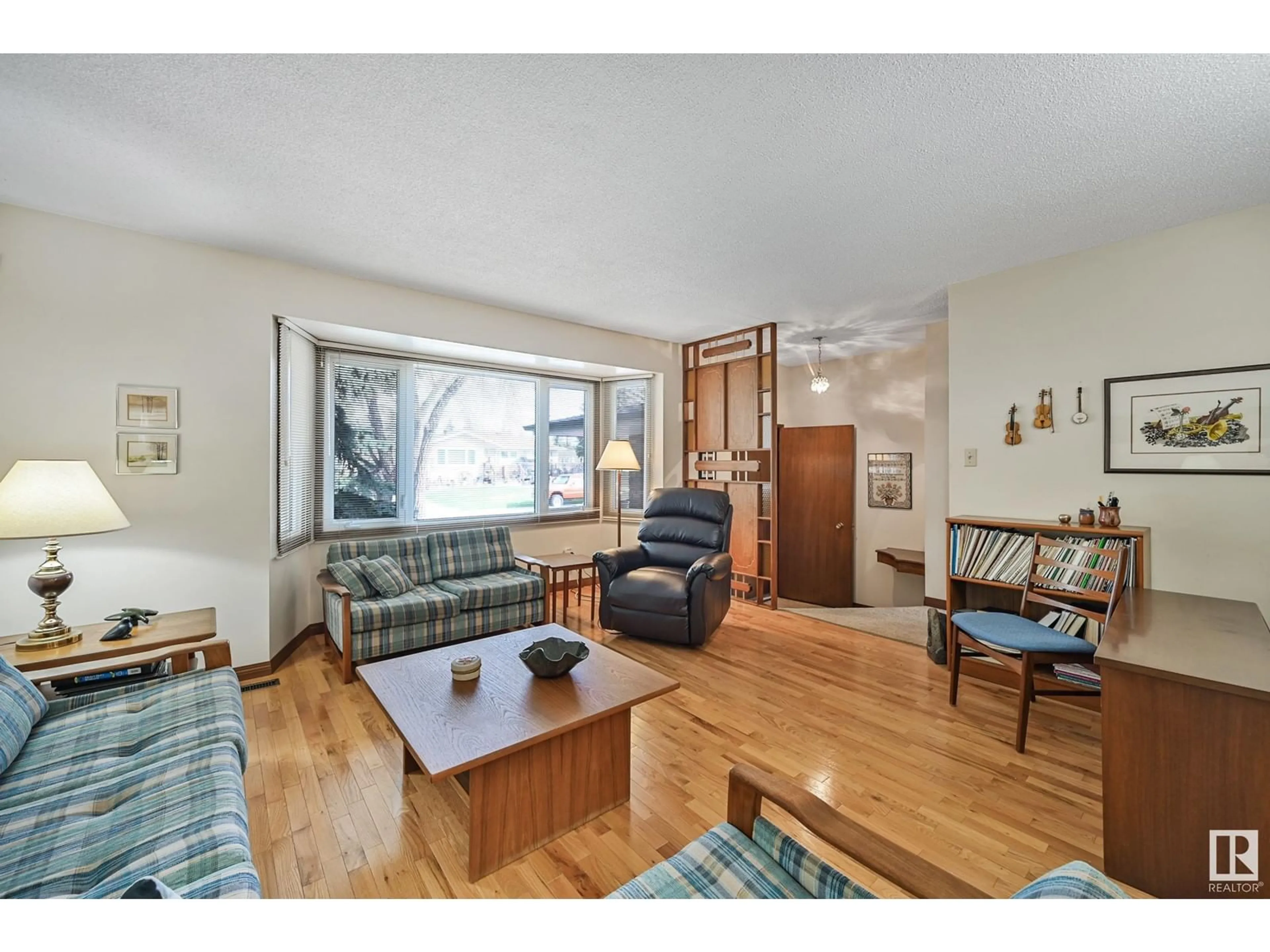 Living room with furniture, wood/laminate floor for 8107 44 AV, Edmonton Alberta T6K0Z3