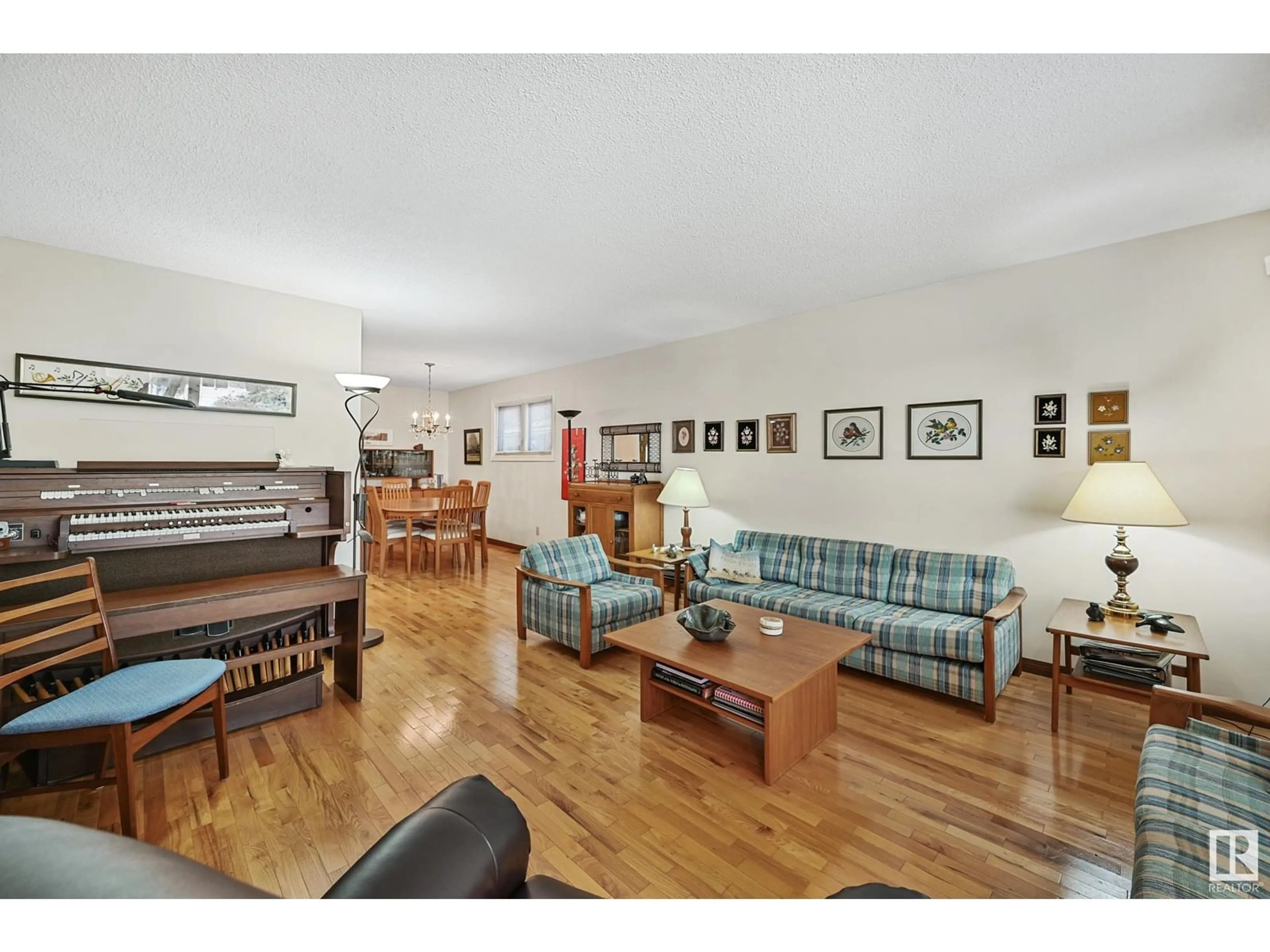 Living room with furniture, wood/laminate floor for 8107 44 AV, Edmonton Alberta T6K0Z3