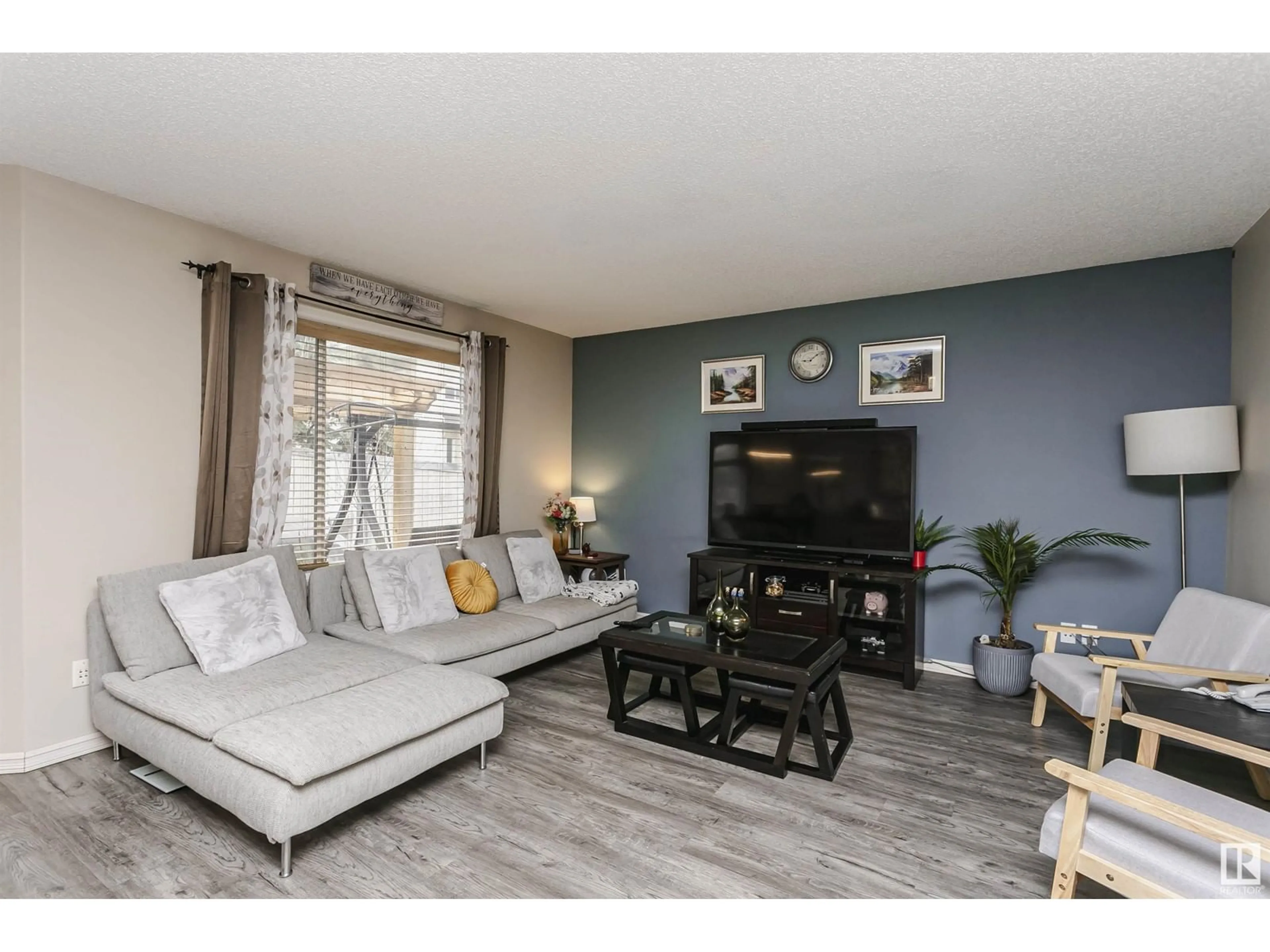 Living room with furniture, wood/laminate floor for 3050 SPENCE WD, Edmonton Alberta T6X0A5