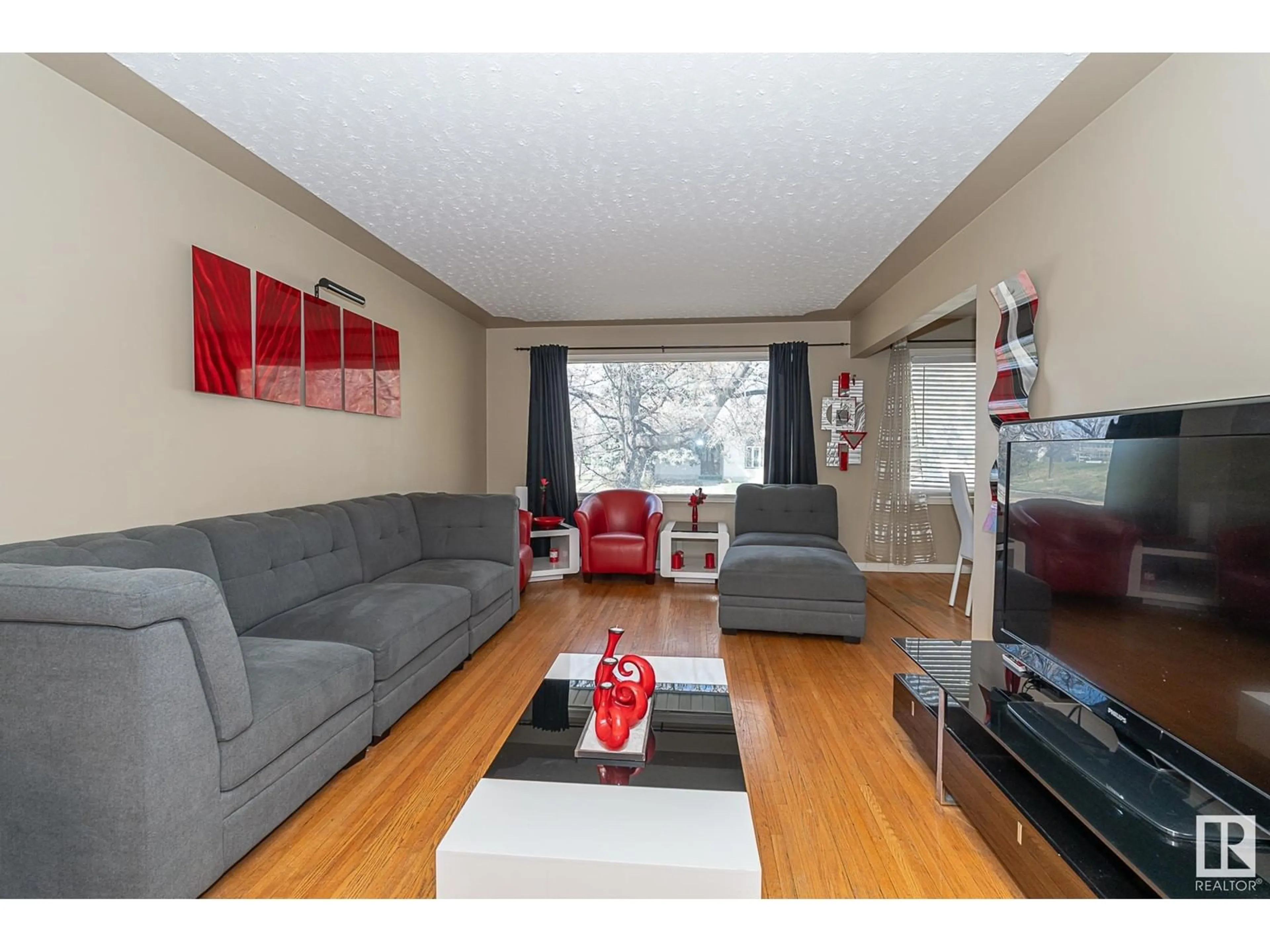 Living room with furniture, wood/laminate floor for NW - 16533 105A AV, Edmonton Alberta T5P0V6