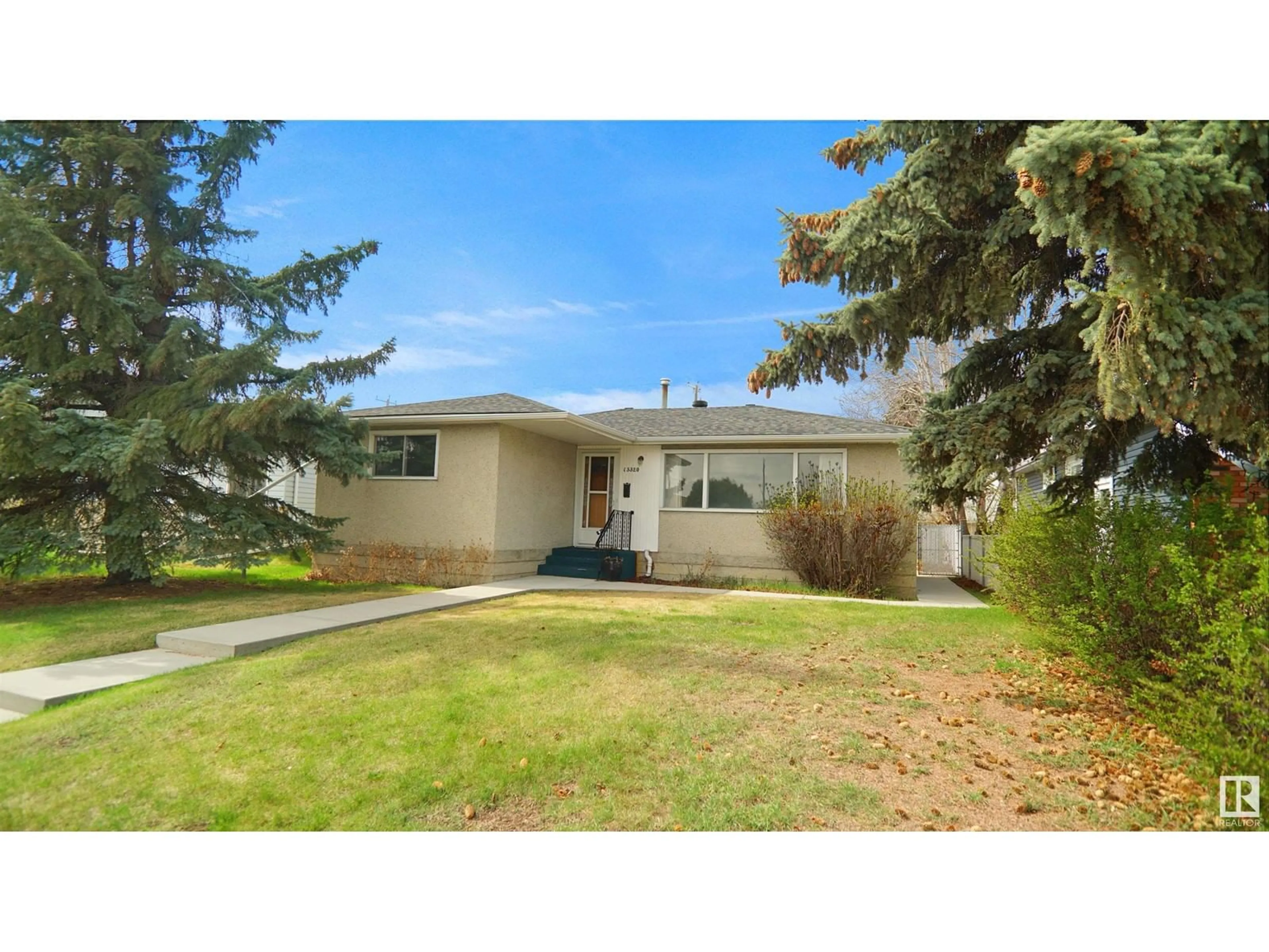 Home with vinyl exterior material, street for 13320 130 ST, Edmonton Alberta T5L1L8