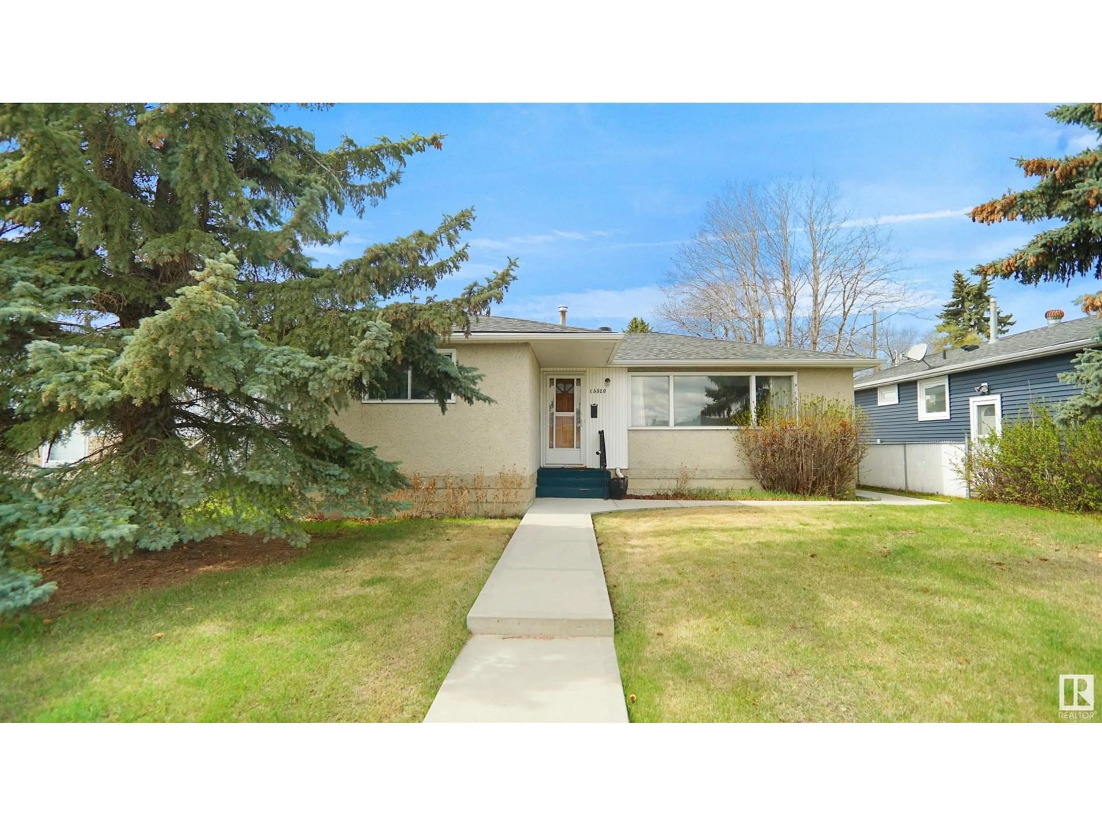 Home with vinyl exterior material, street for 13320 130 ST, Edmonton Alberta T5L1L8