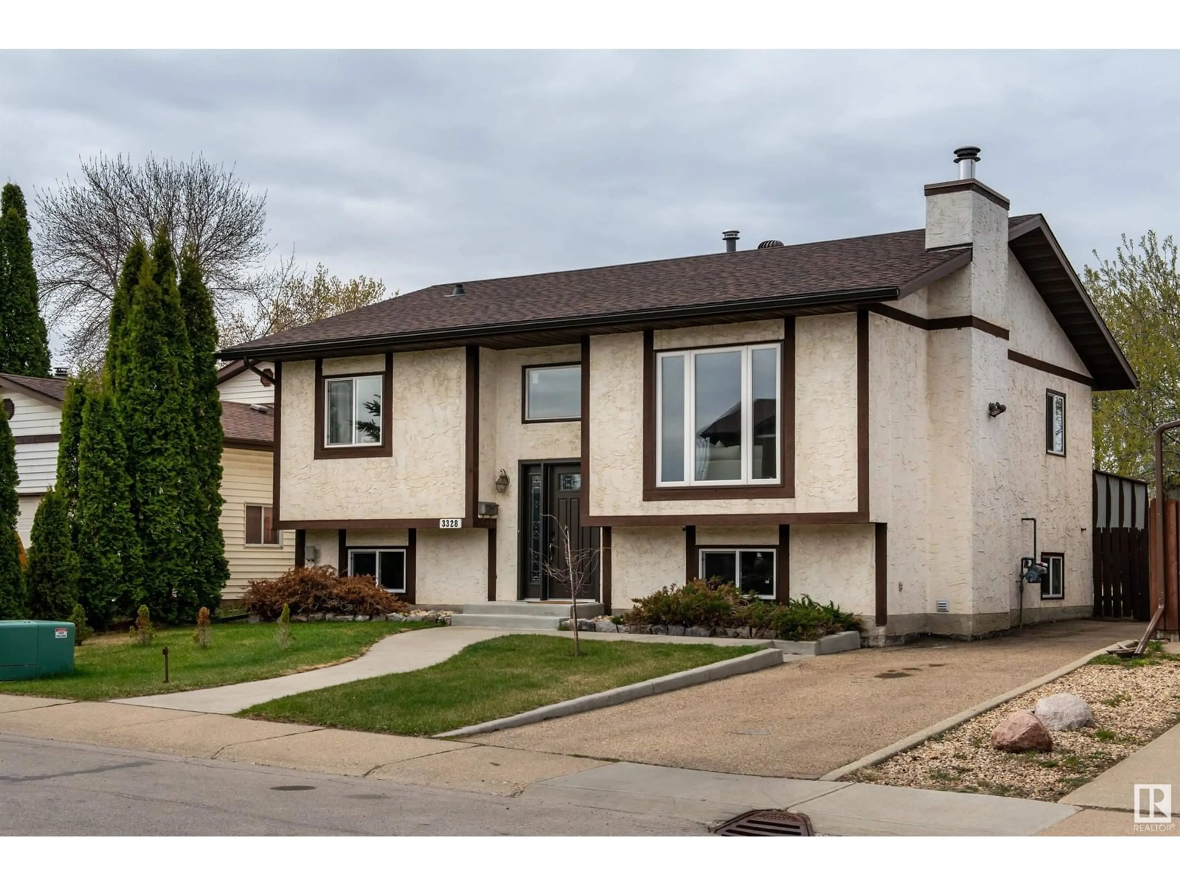 Home with vinyl exterior material, street for 3328 145 AV, Edmonton Alberta T5Y2E5