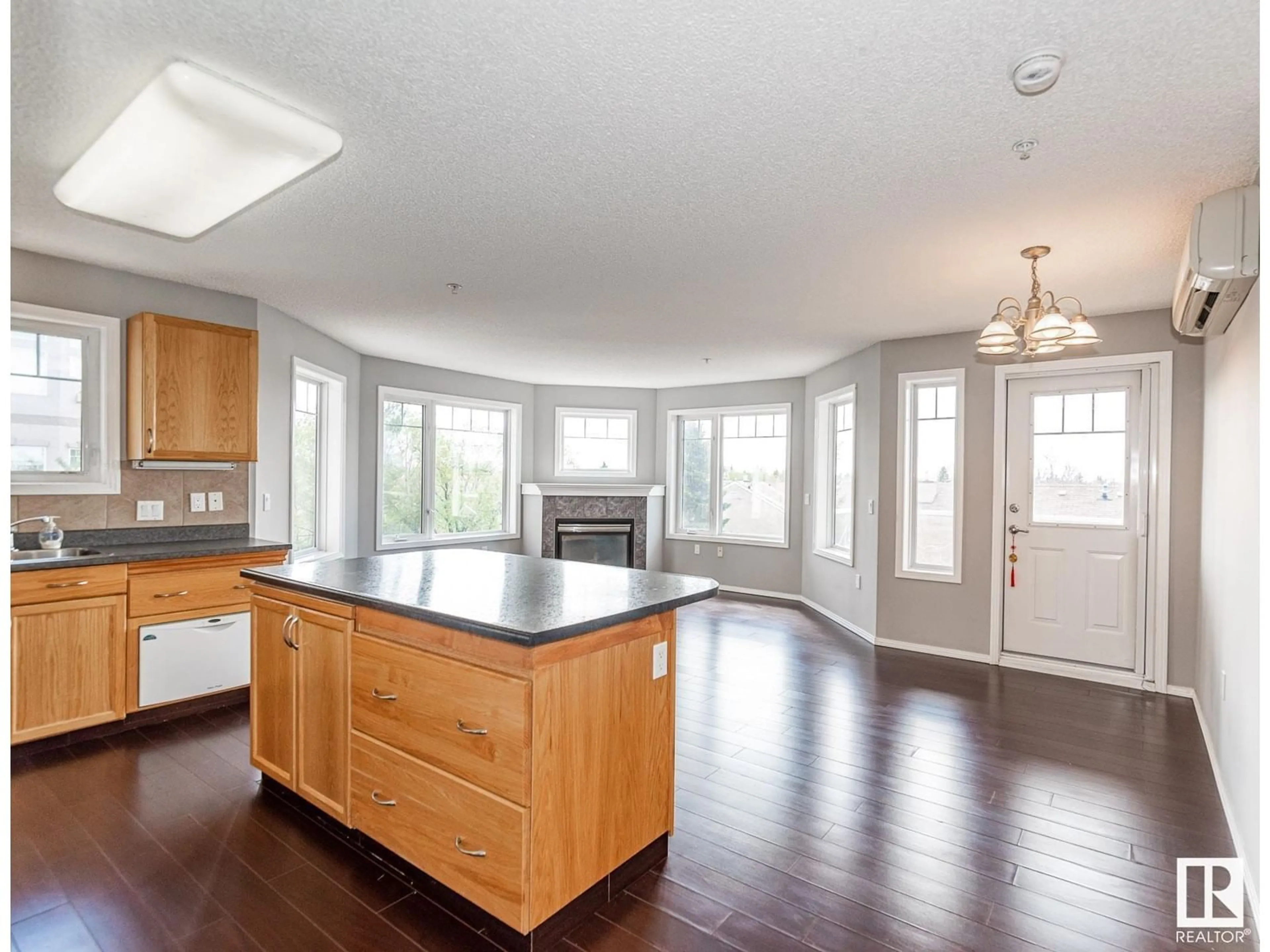 Open concept kitchen, wood/laminate floor for #311 - 2420 108 ST, Edmonton Alberta T6J7J3
