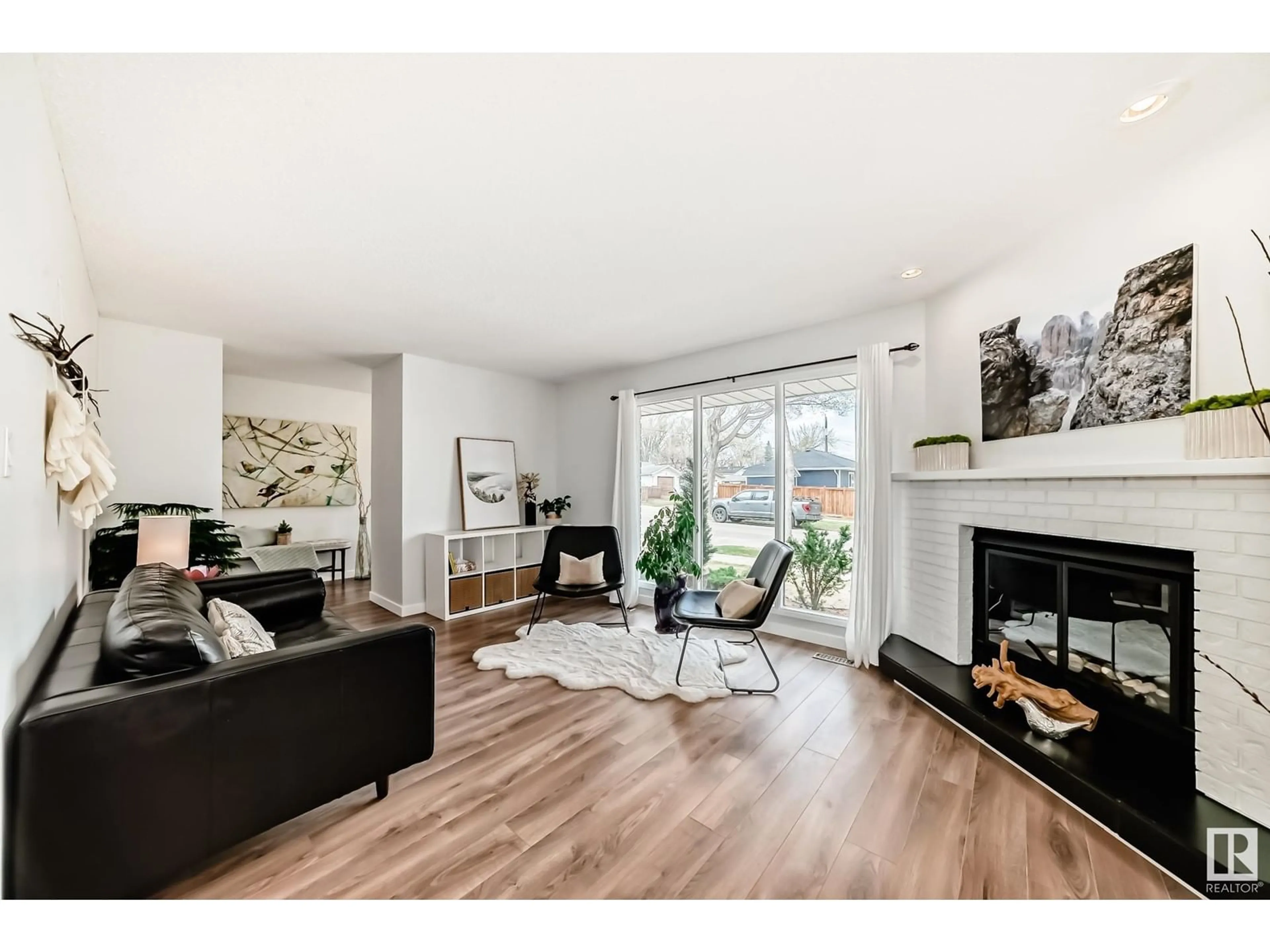 Living room with furniture, wood/laminate floor for 8107 105 AV, Edmonton Alberta T6A1B3