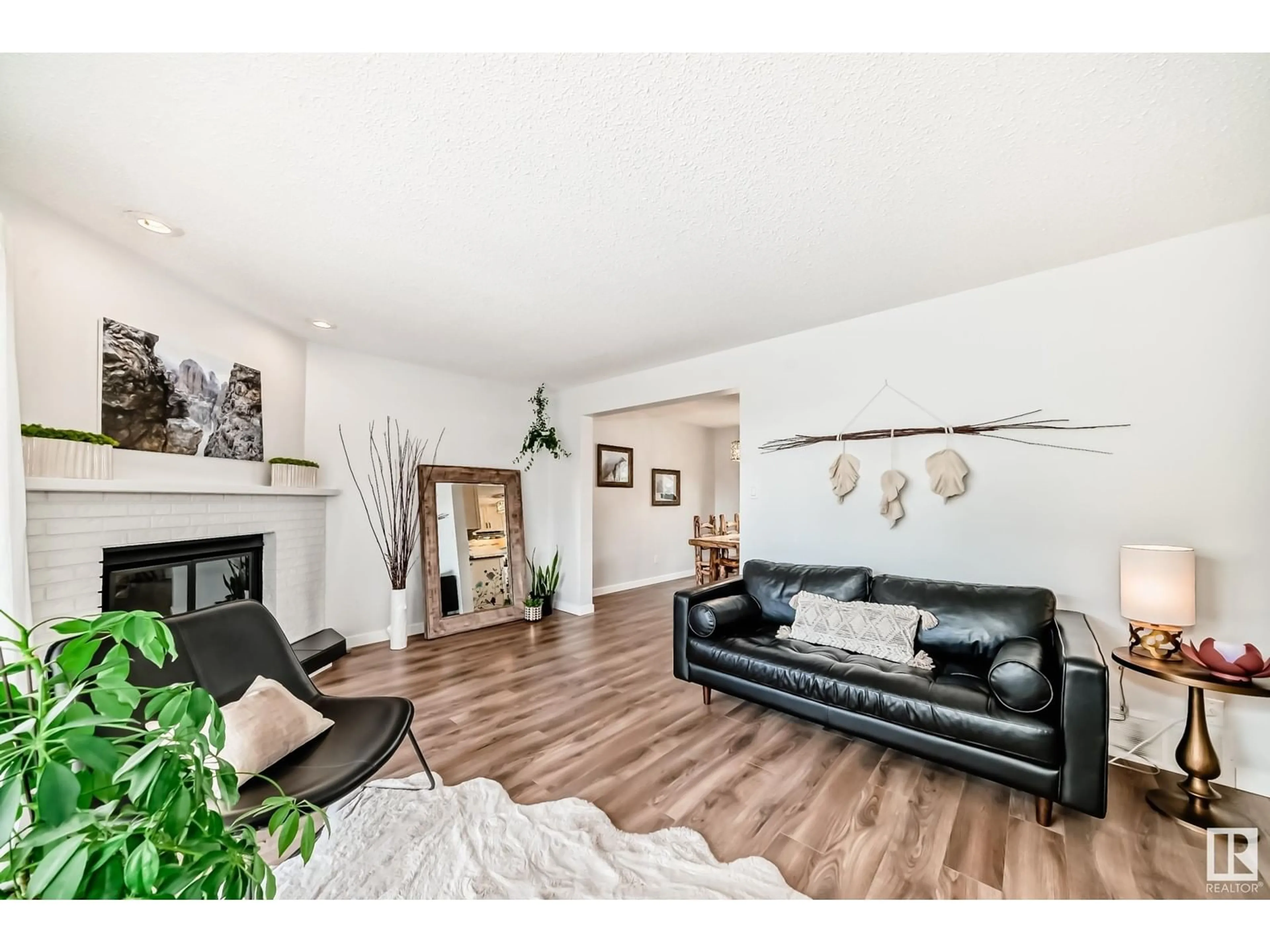 Living room with furniture, wood/laminate floor for 8107 105 AV, Edmonton Alberta T6A1B3