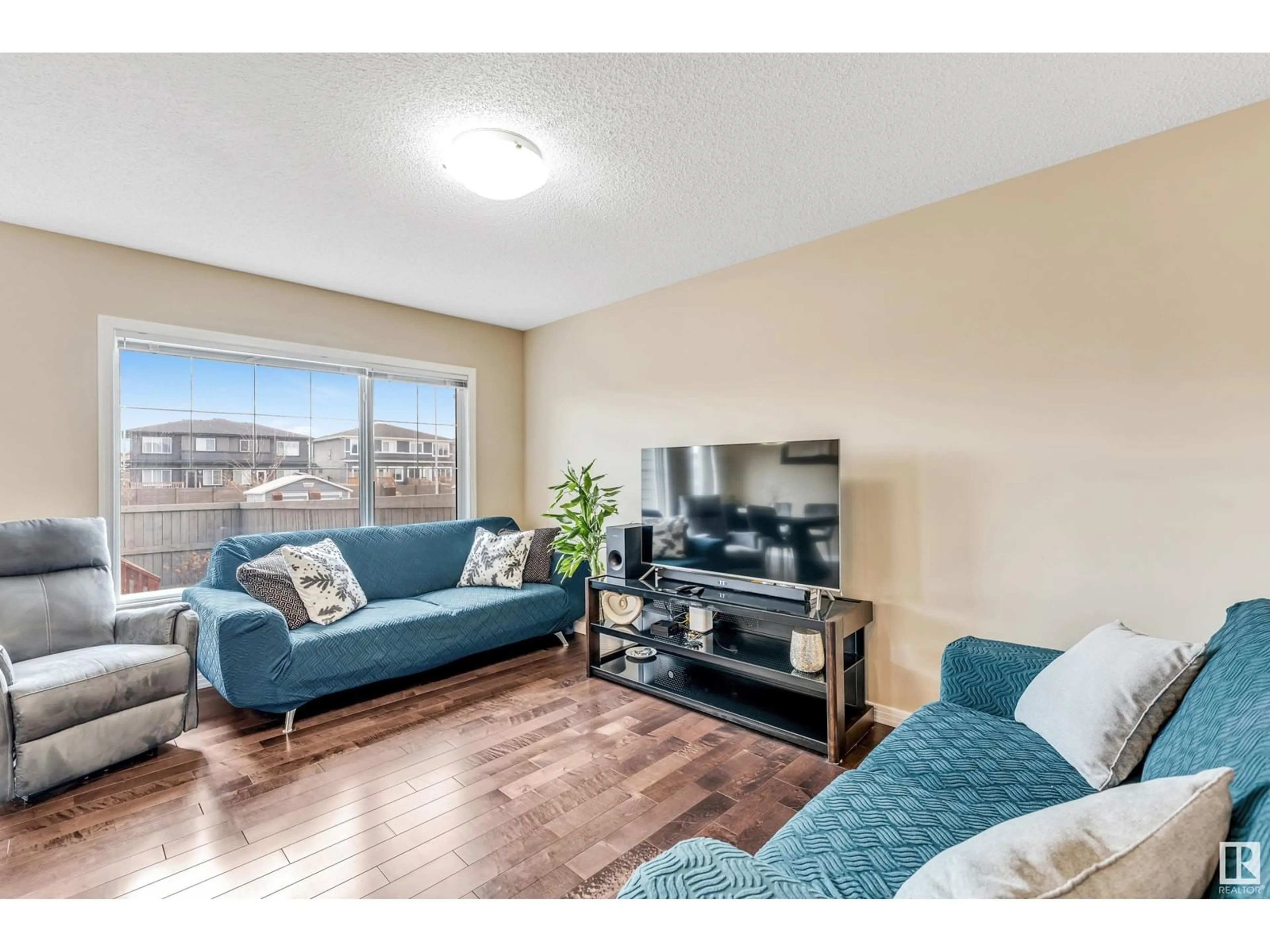 Living room with furniture, wood/laminate floor for SW - 17513 13 AV, Edmonton Alberta T6W2J8