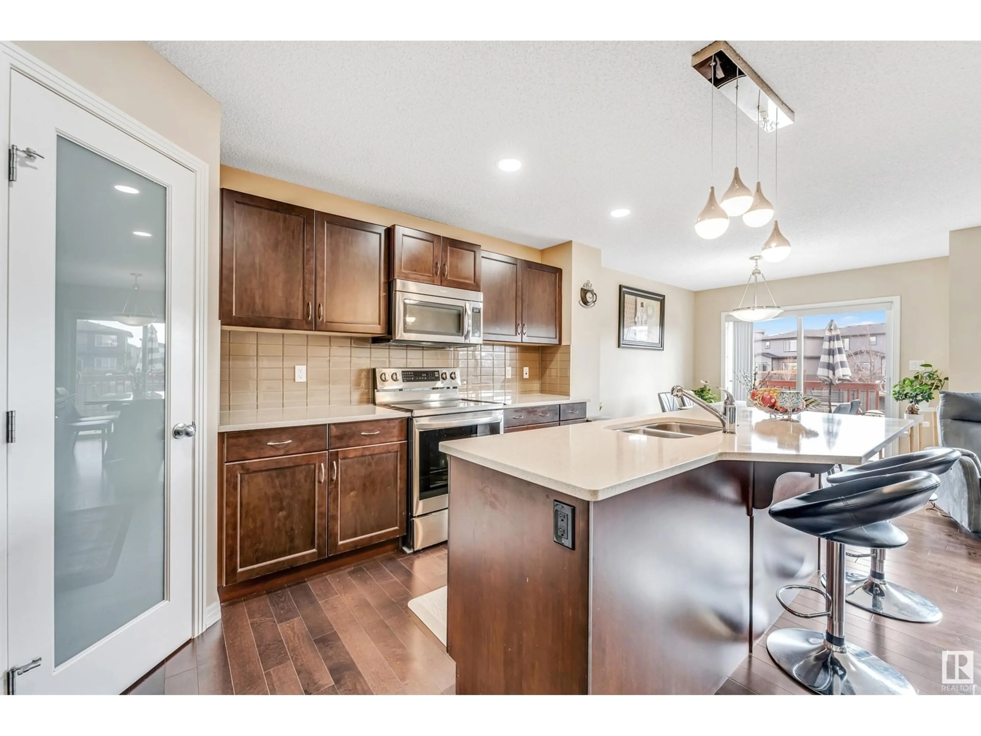 Open concept kitchen, wood/laminate floor for SW - 17513 13 AV, Edmonton Alberta T6W2J8