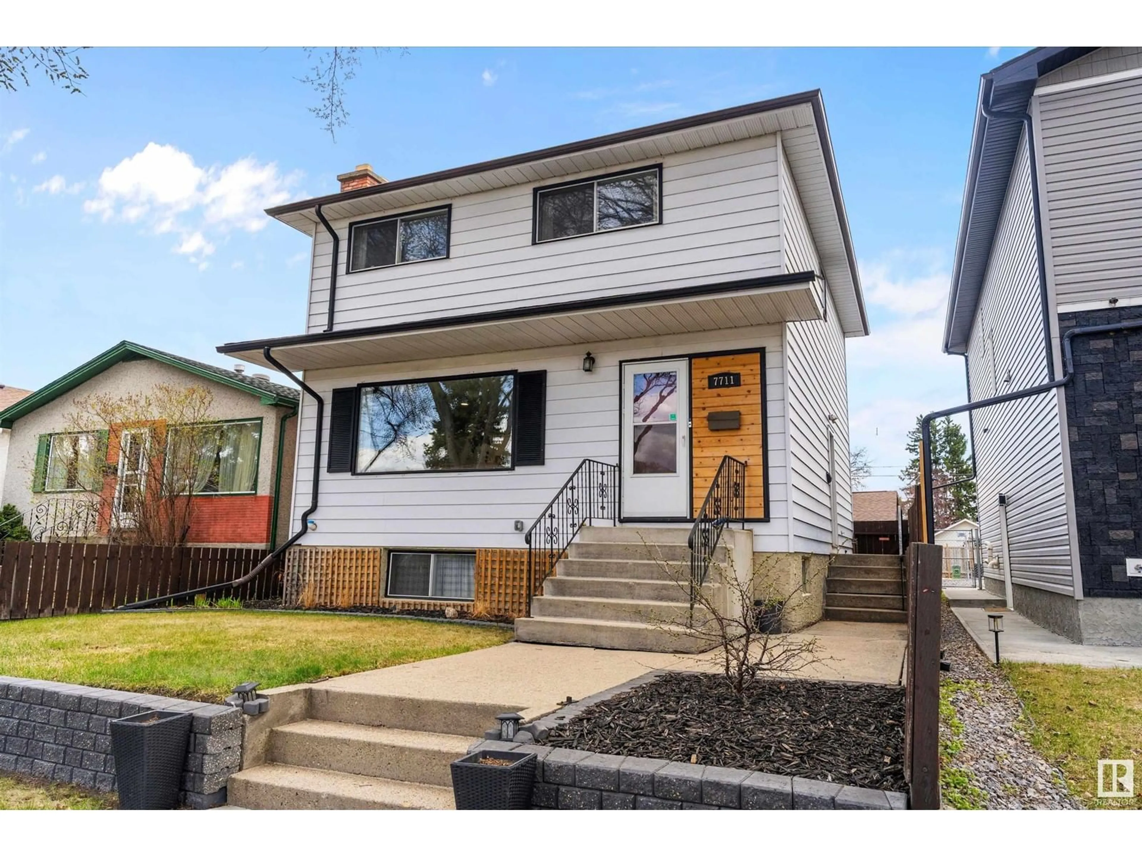 Home with vinyl exterior material, street for 7711 80 AV, Edmonton Alberta T6C0S3
