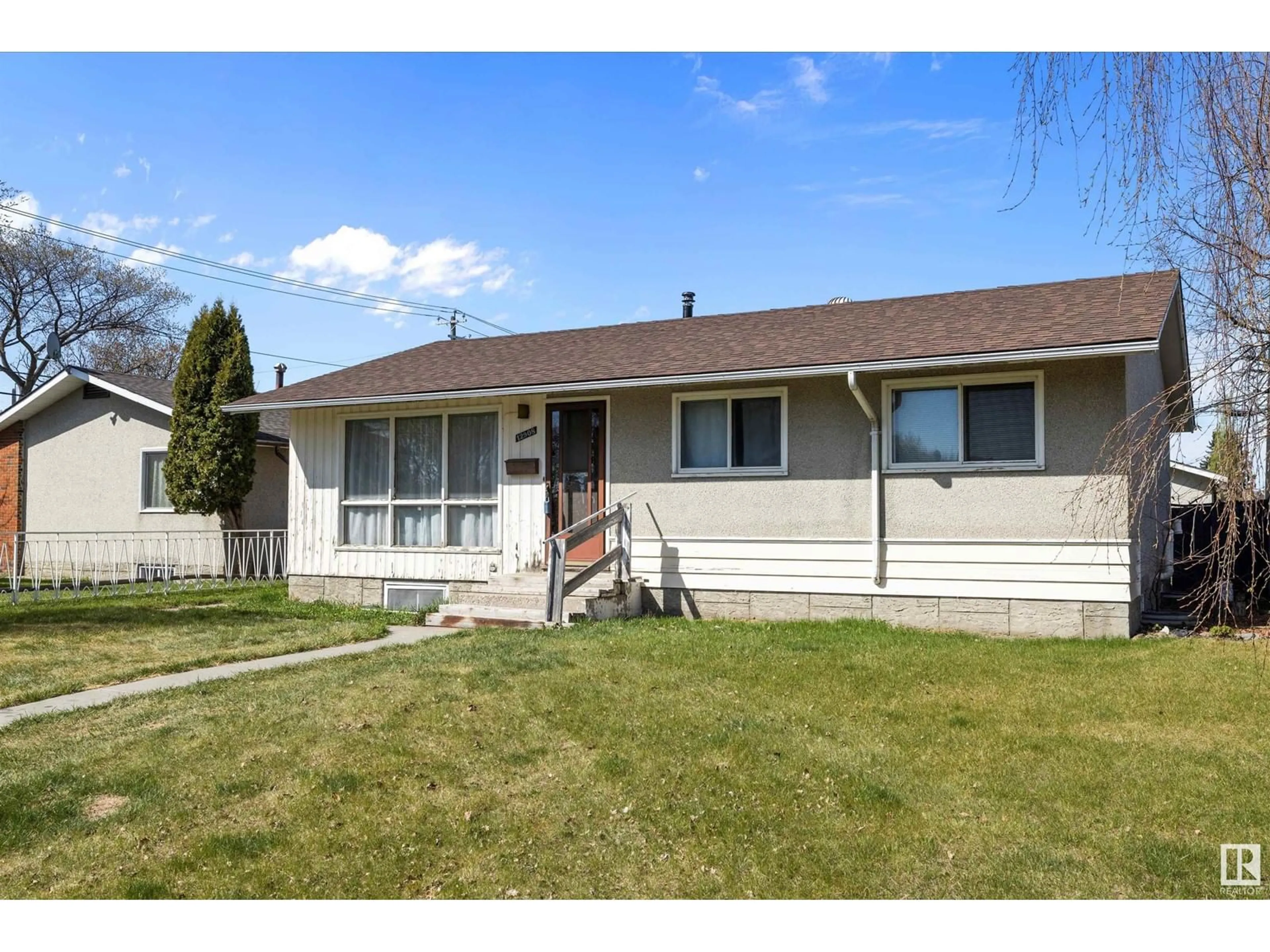 Home with vinyl exterior material, street for 12908 133 ST NW, Edmonton Alberta T5L1S8