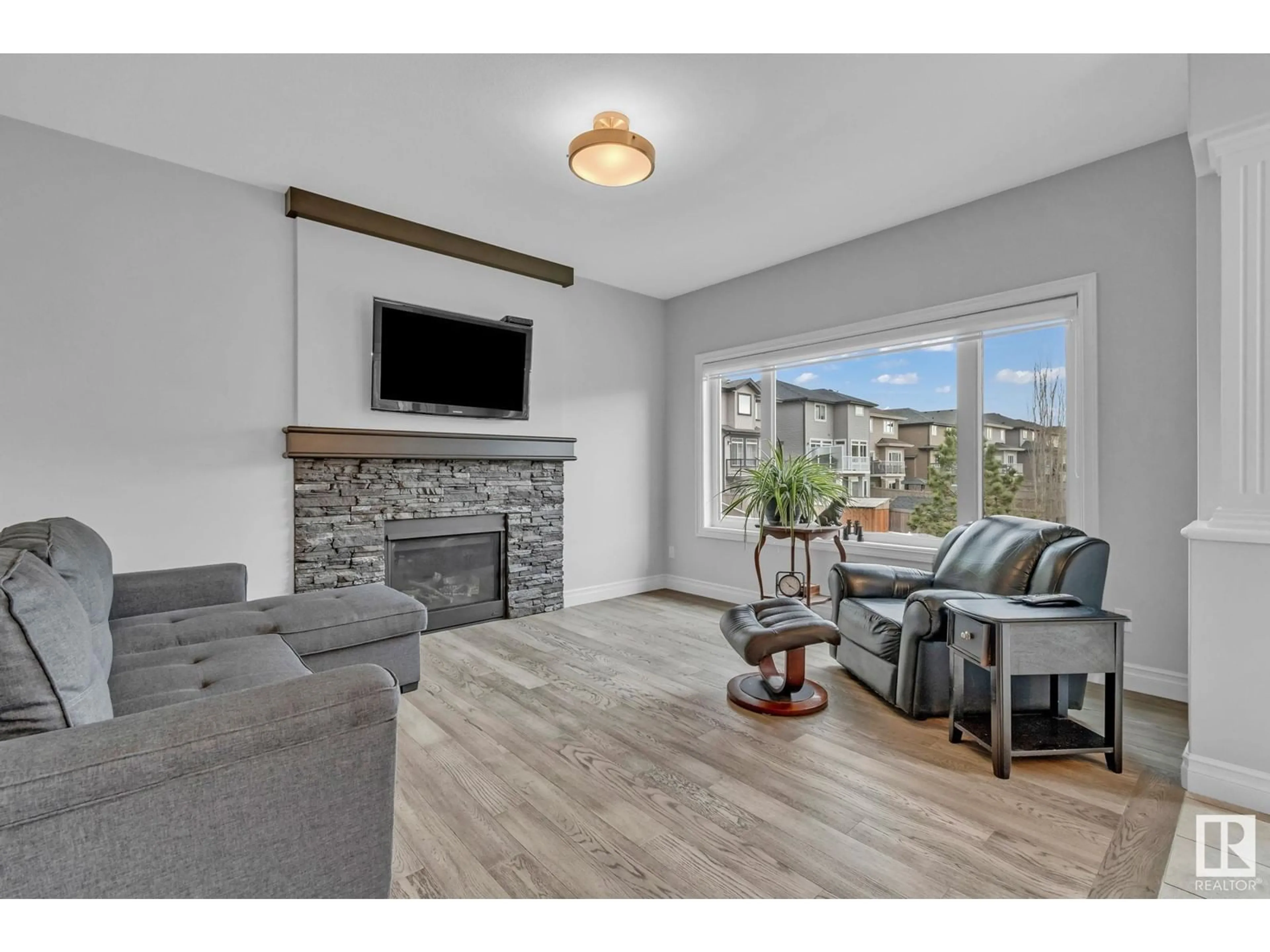 Living room with furniture, wood/laminate floor for NW NW - 2048 REDTAIL CM, Edmonton Alberta T5S0H3