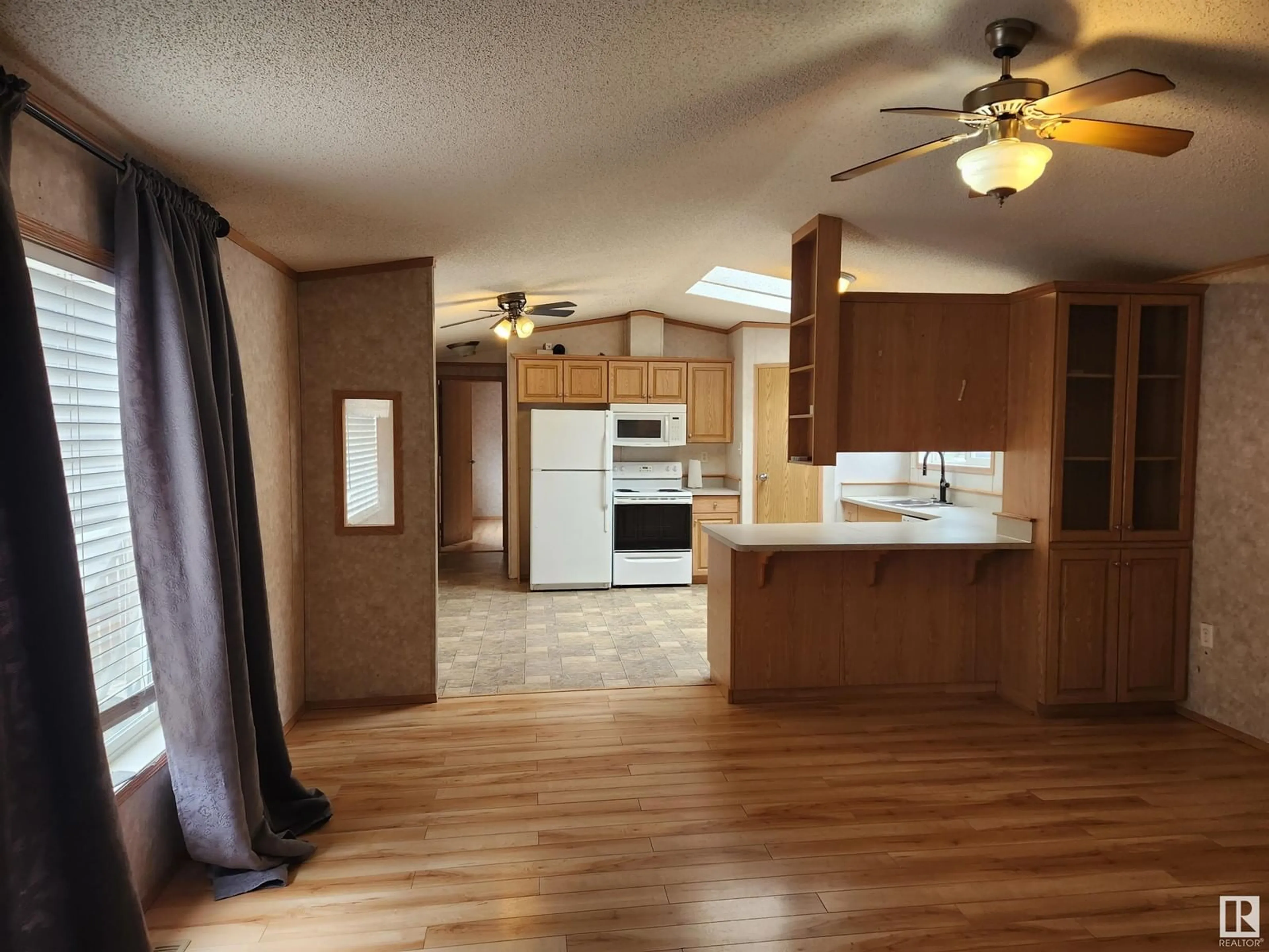 Open concept kitchen, wood/laminate floor for 963 53222 RR 272, Rural Parkland County Alberta T7X3R5