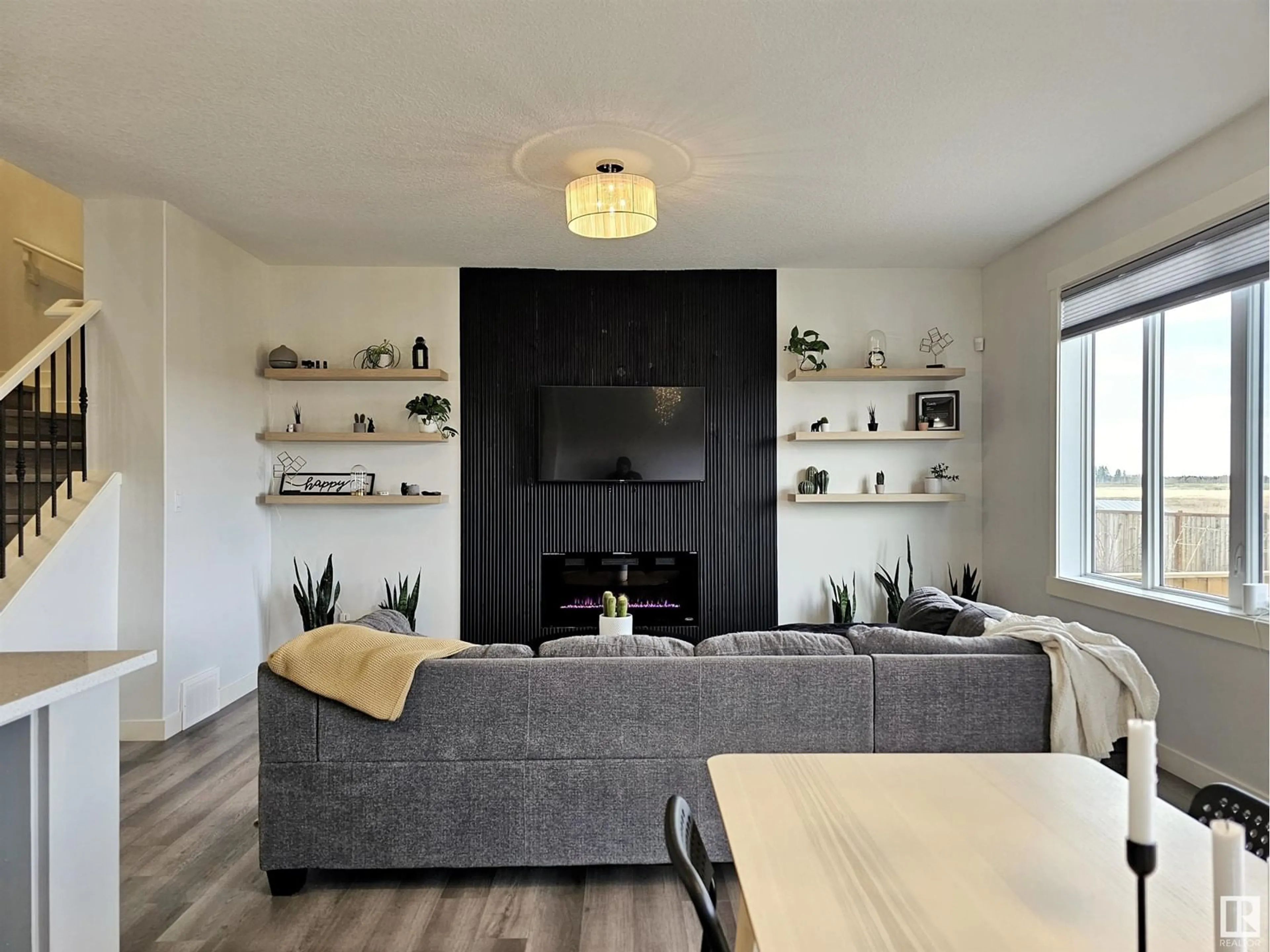 Living room with furniture, wood/laminate floor for 5024 53 AVE, Calmar Alberta T0C0V0