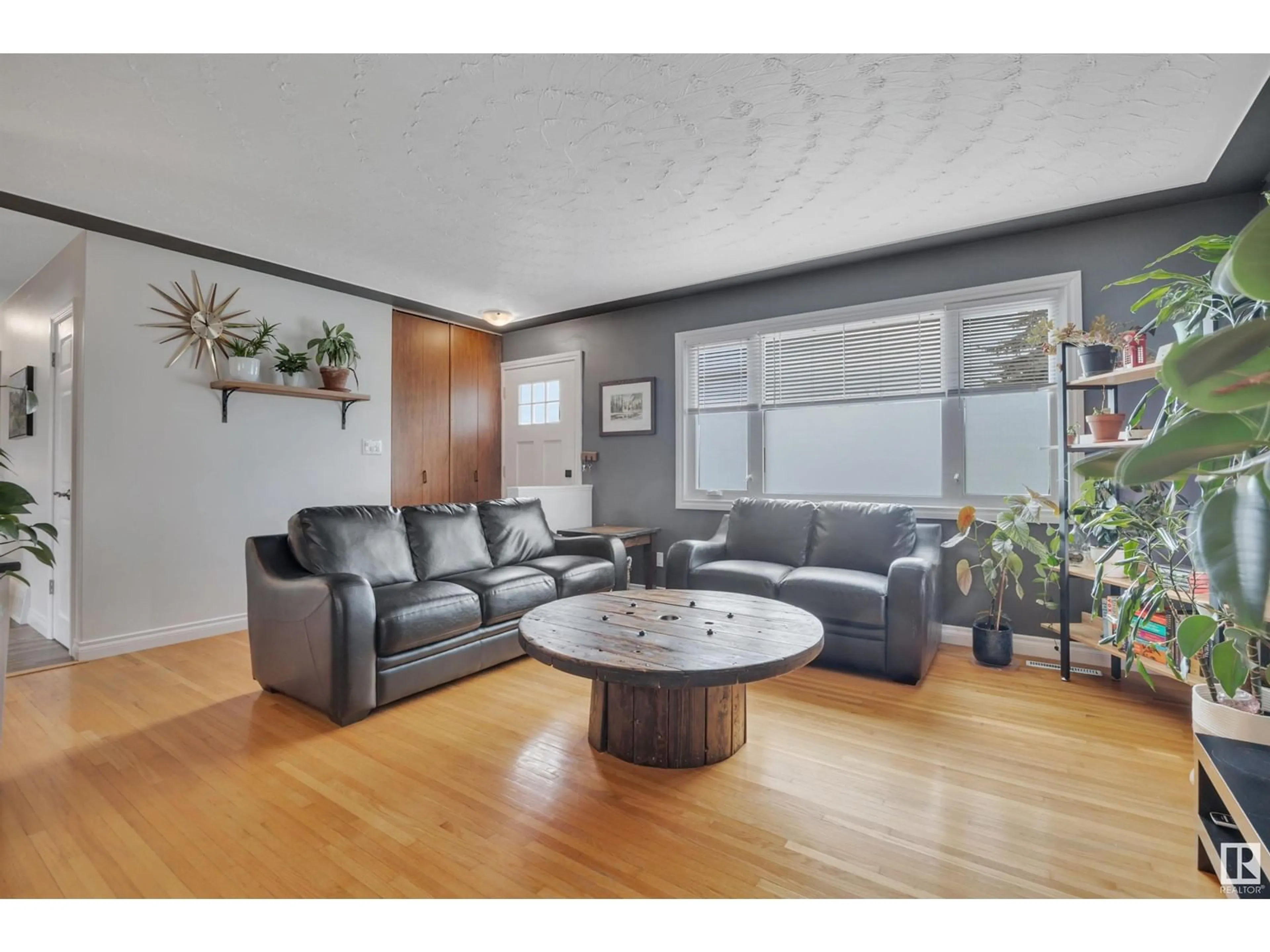 Living room with furniture, wood/laminate floor for 10932 136 AV, Edmonton Alberta T5E1W7