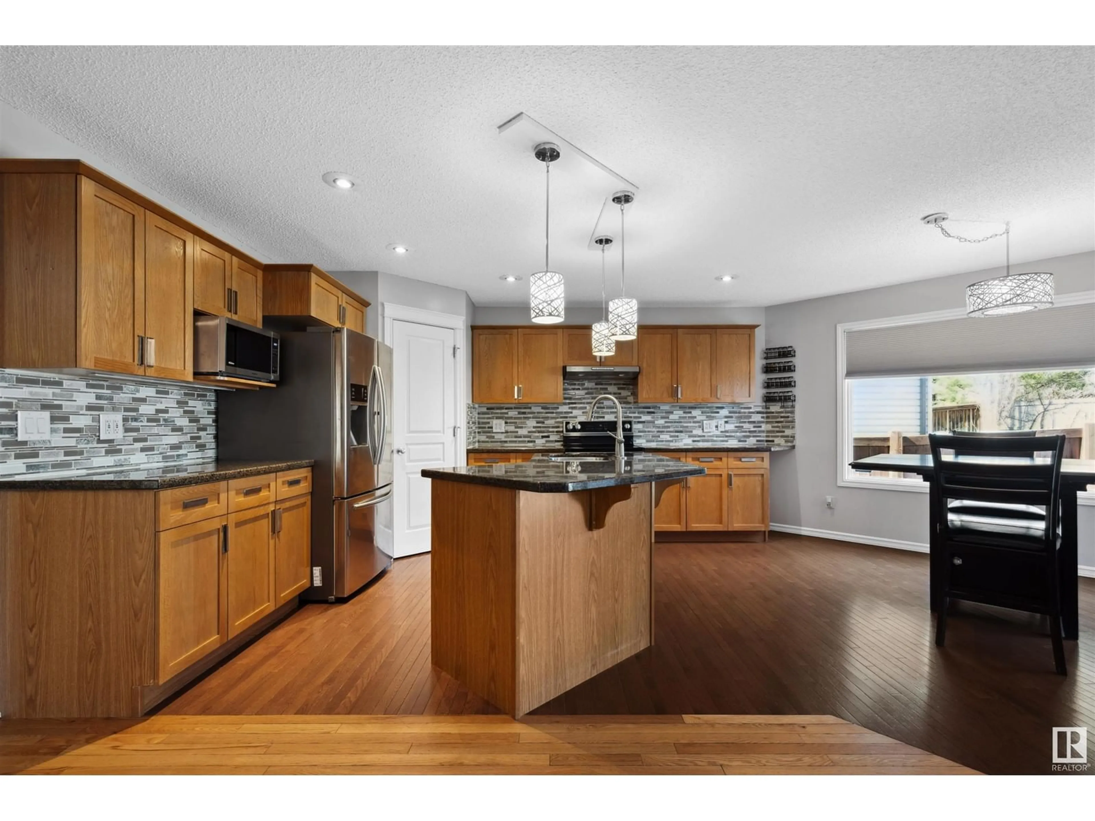 Open concept kitchen, wood/laminate floor for 8918 179A AV, Edmonton Alberta T5Z0A6