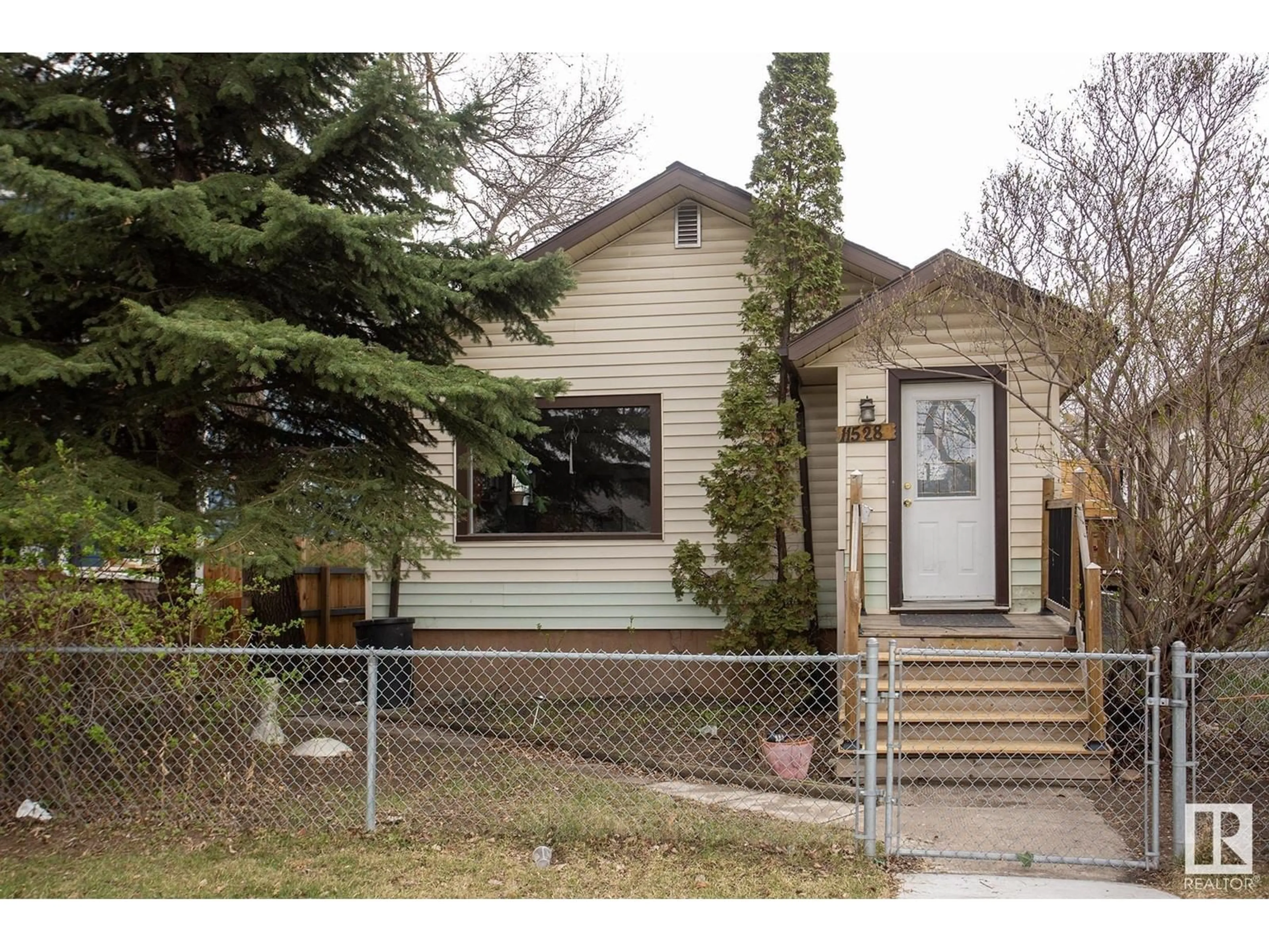 Home with vinyl exterior material, street for 11528 93 ST, Edmonton Alberta T5G1C7
