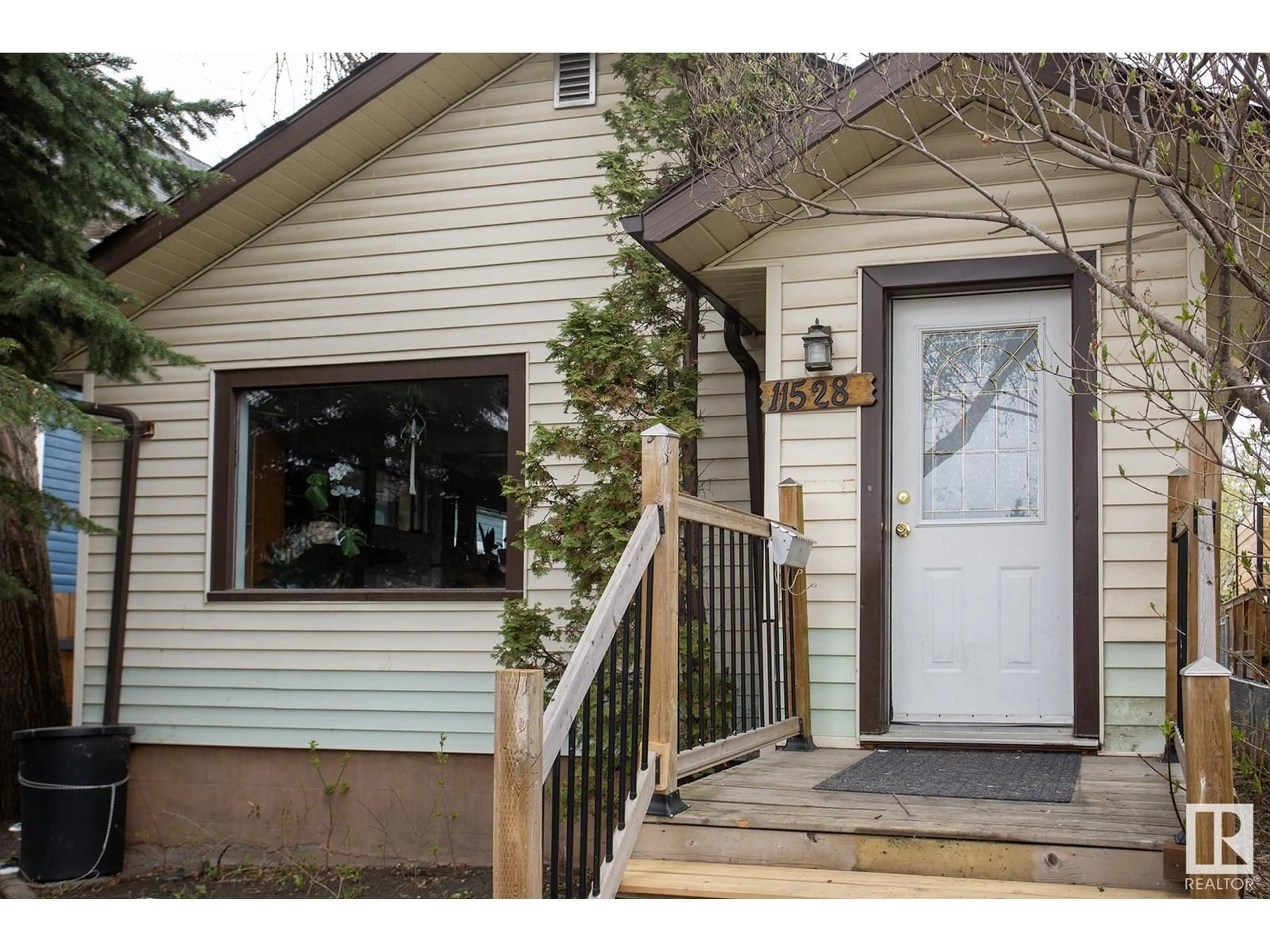 Home with vinyl exterior material, street for 11528 93 ST, Edmonton Alberta T5G1C7