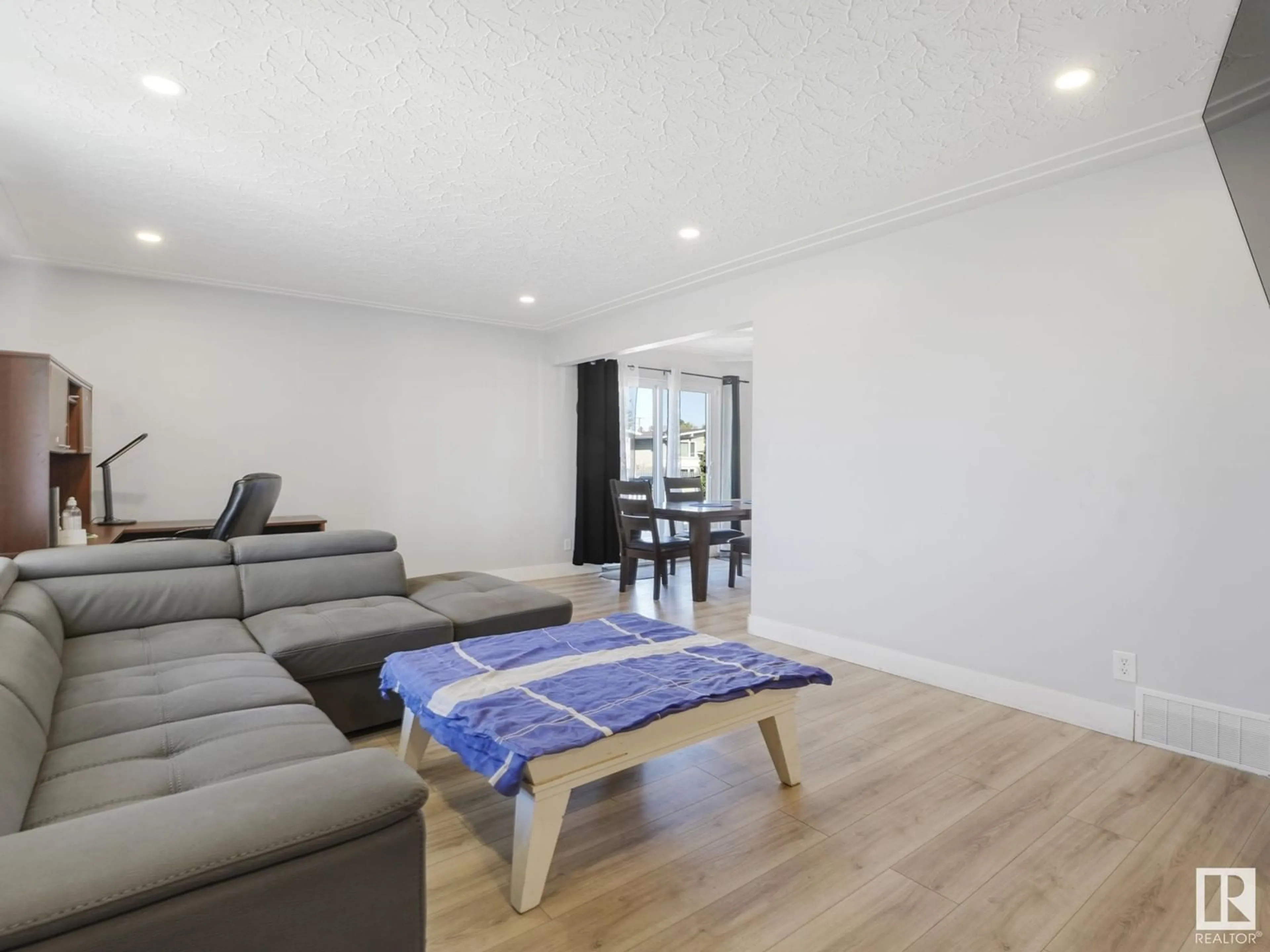 Living room with furniture, wood/laminate floor for 8214 127 AV, Edmonton Alberta T5E0A2