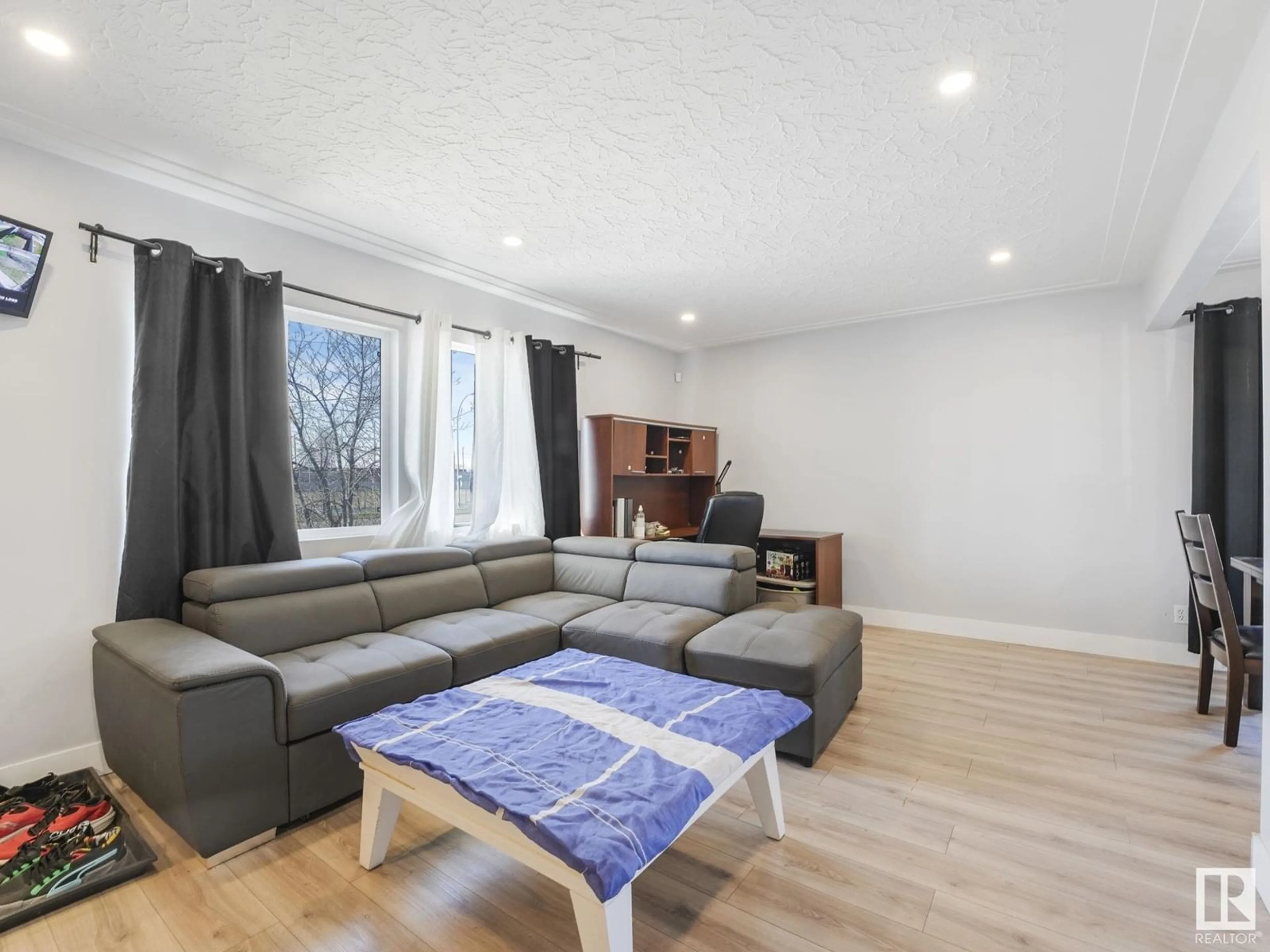 Living room with furniture, wood/laminate floor for 8214 127 AV, Edmonton Alberta T5E0A2