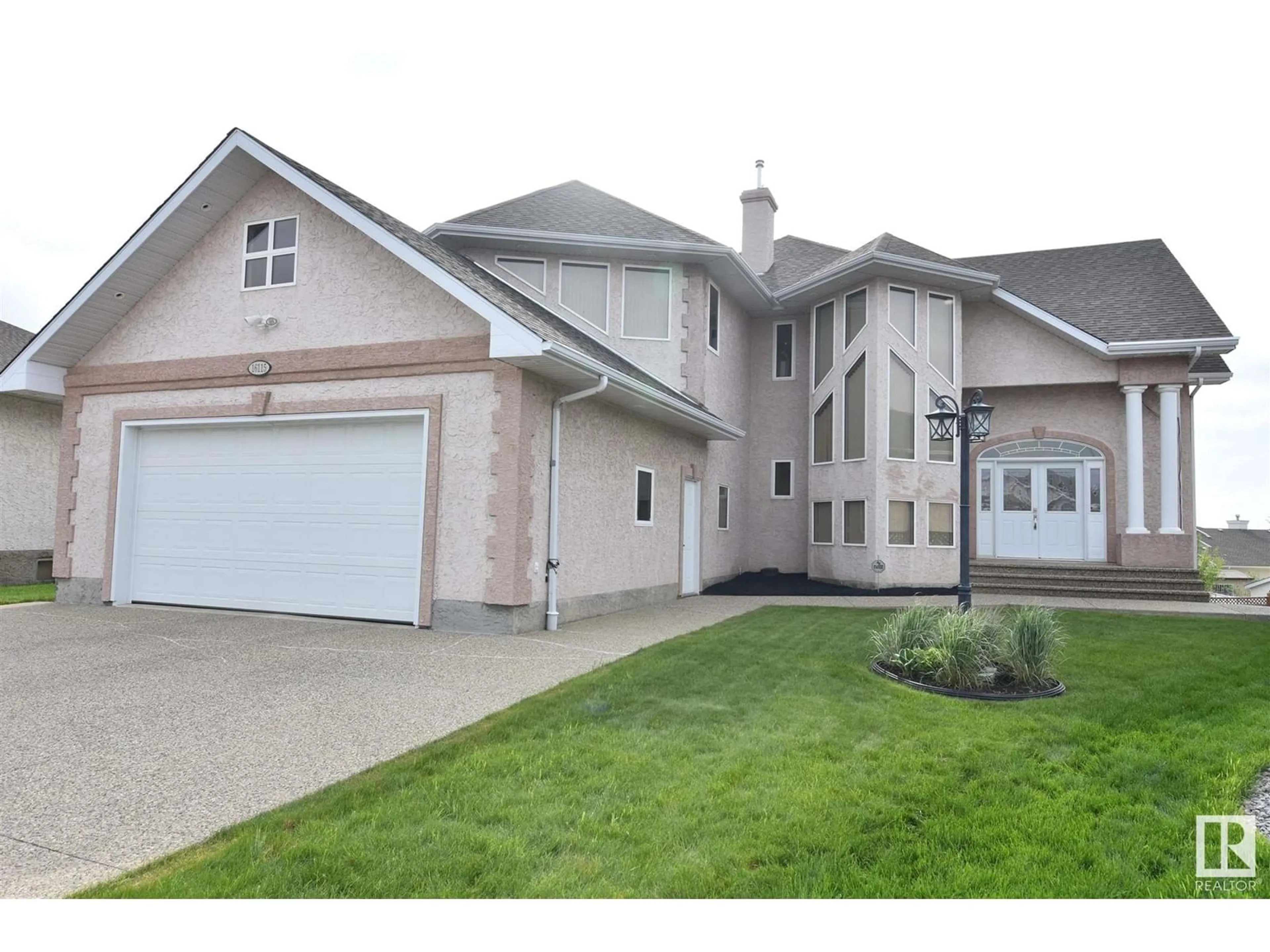 Home with vinyl exterior material, street for 16115 57 ST, Edmonton Alberta T5Y2T1
