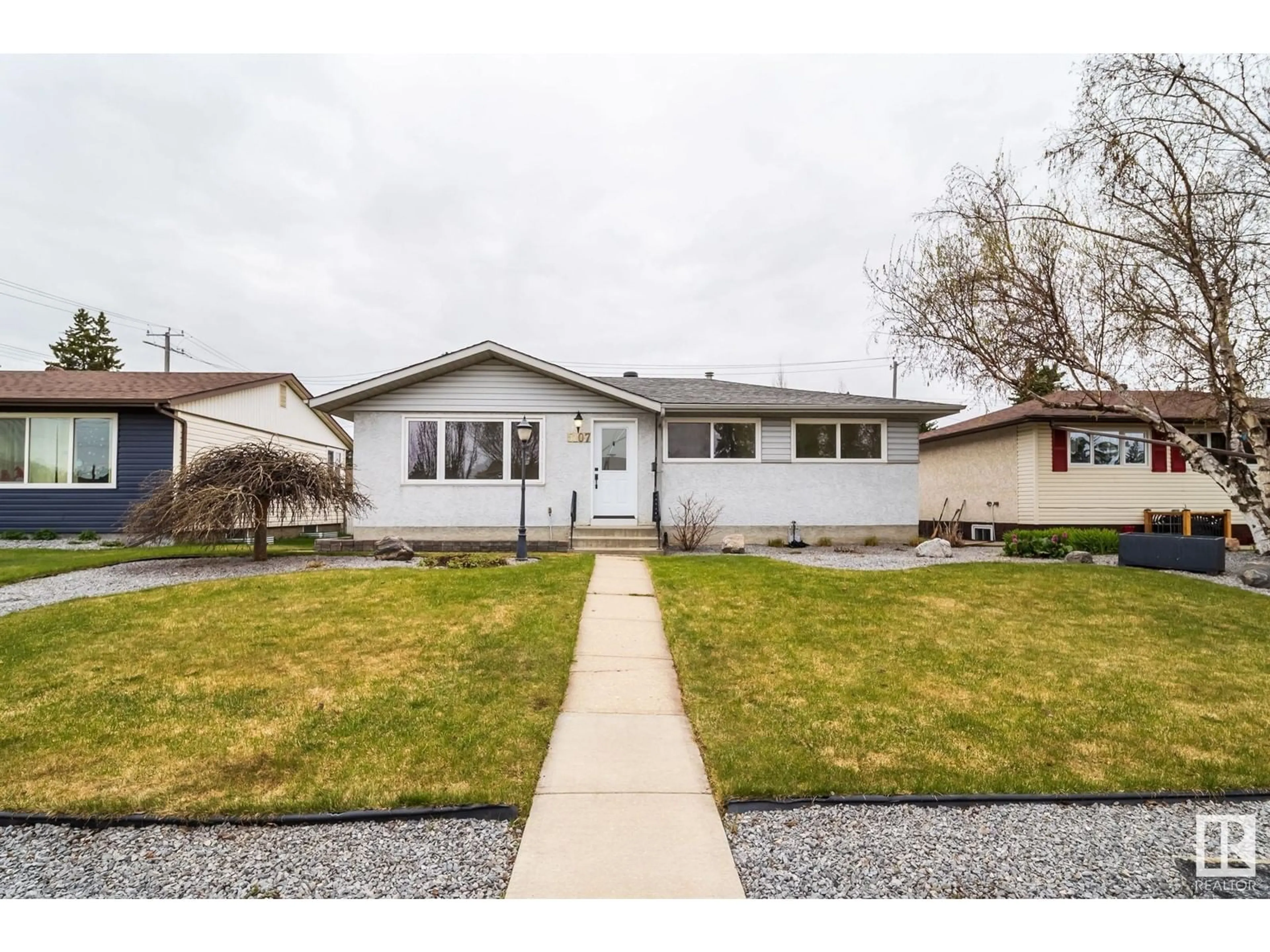 Home with vinyl exterior material, street for 5107 103 AV, Edmonton Alberta T6A0T1