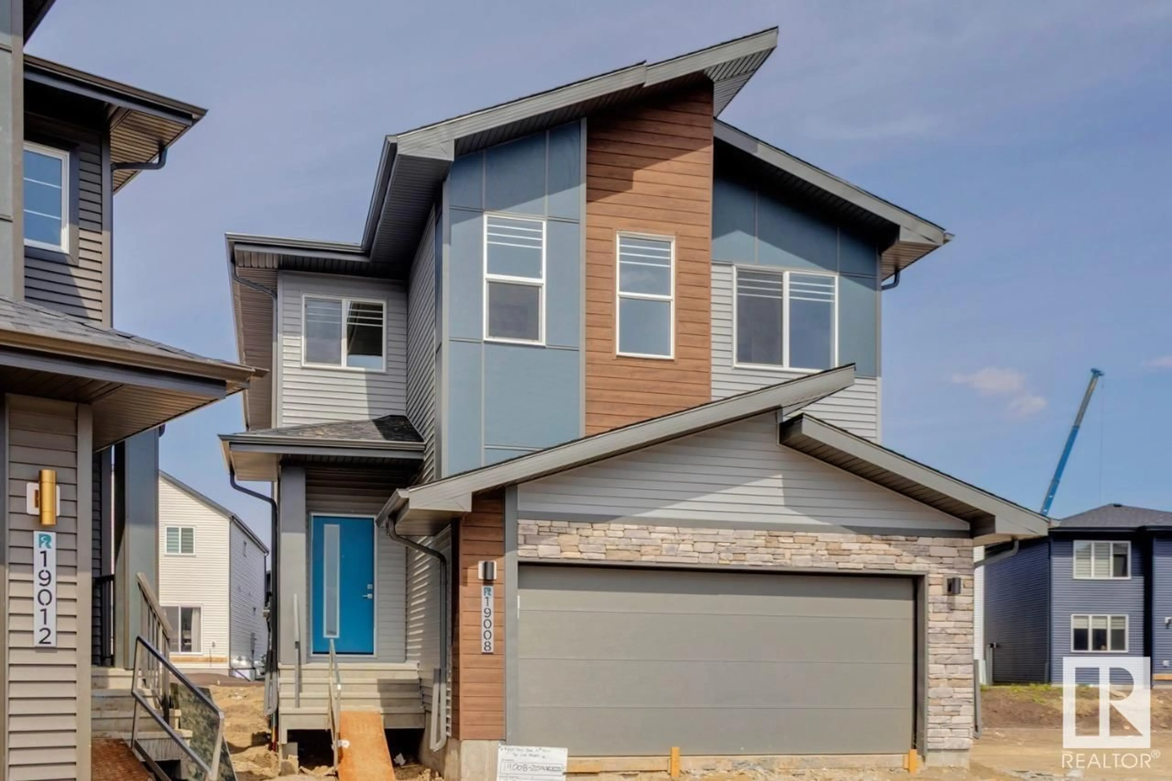 Home with vinyl exterior material, street for NW - 19008 20 AV, Edmonton Alberta T6M3A7