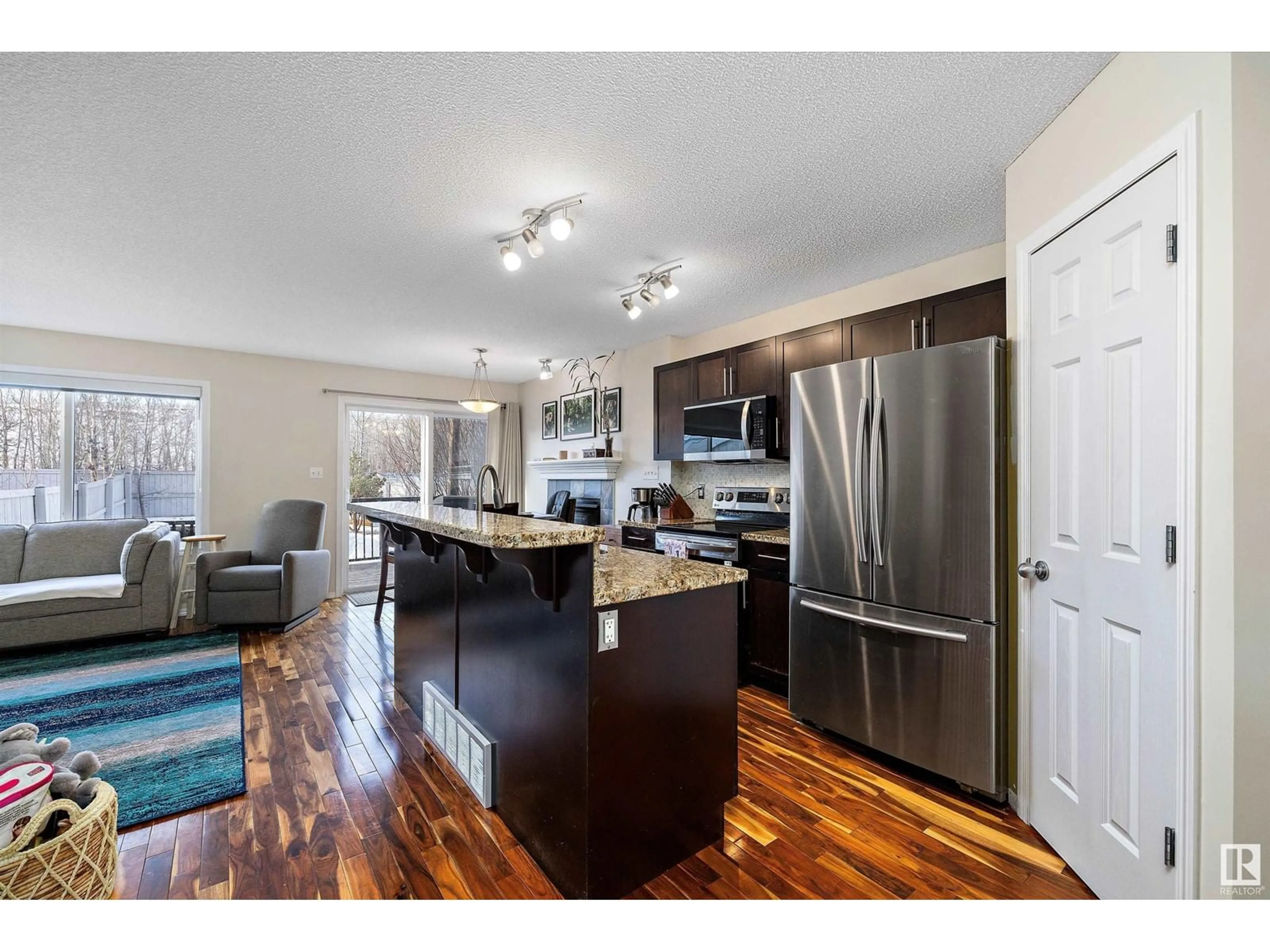 Open concept kitchen, wood/laminate floor for 6014 214 ST NW, Edmonton Alberta T6M0H8