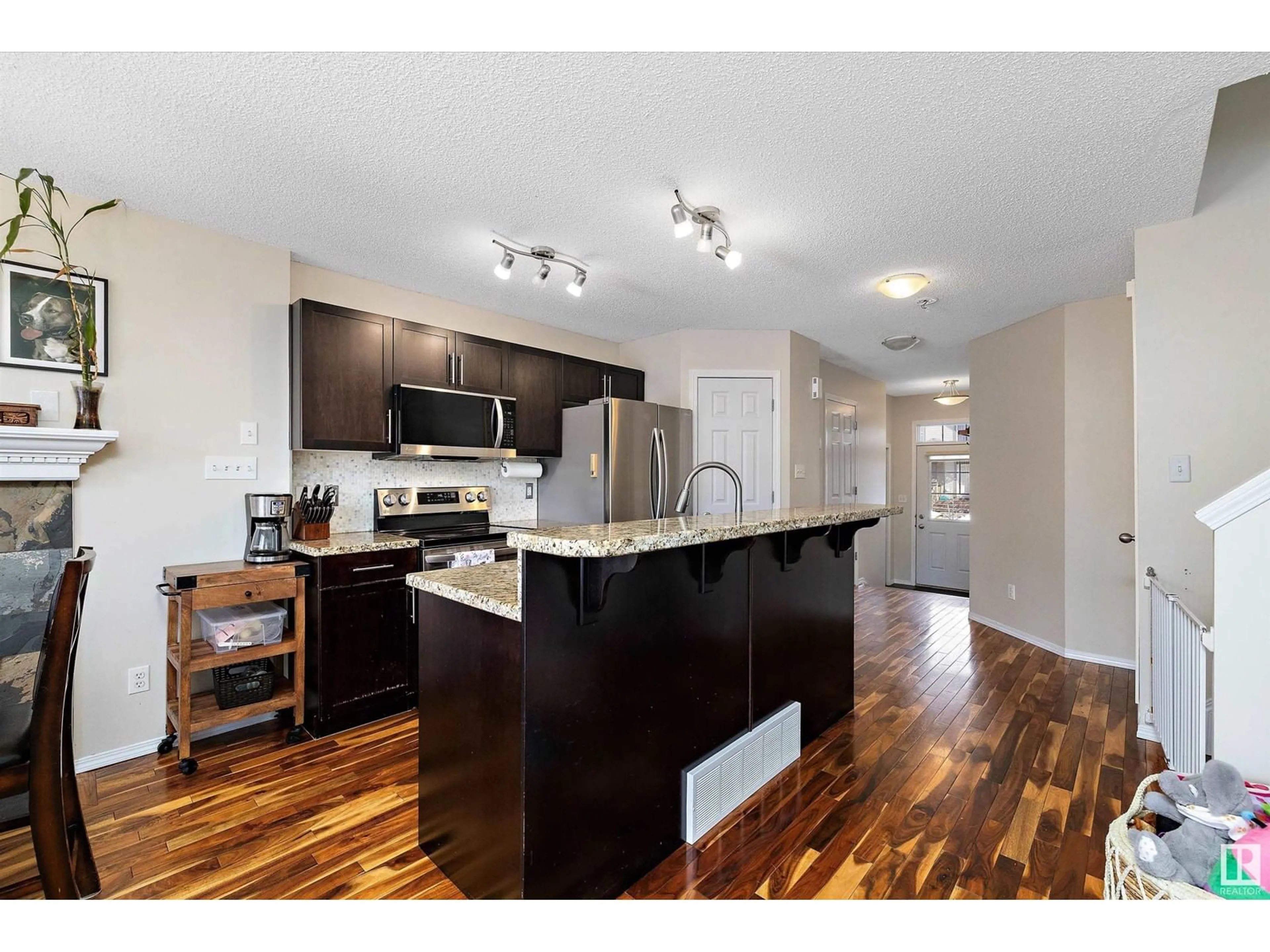 Open concept kitchen, wood/laminate floor for 6014 214 ST NW, Edmonton Alberta T6M0H8