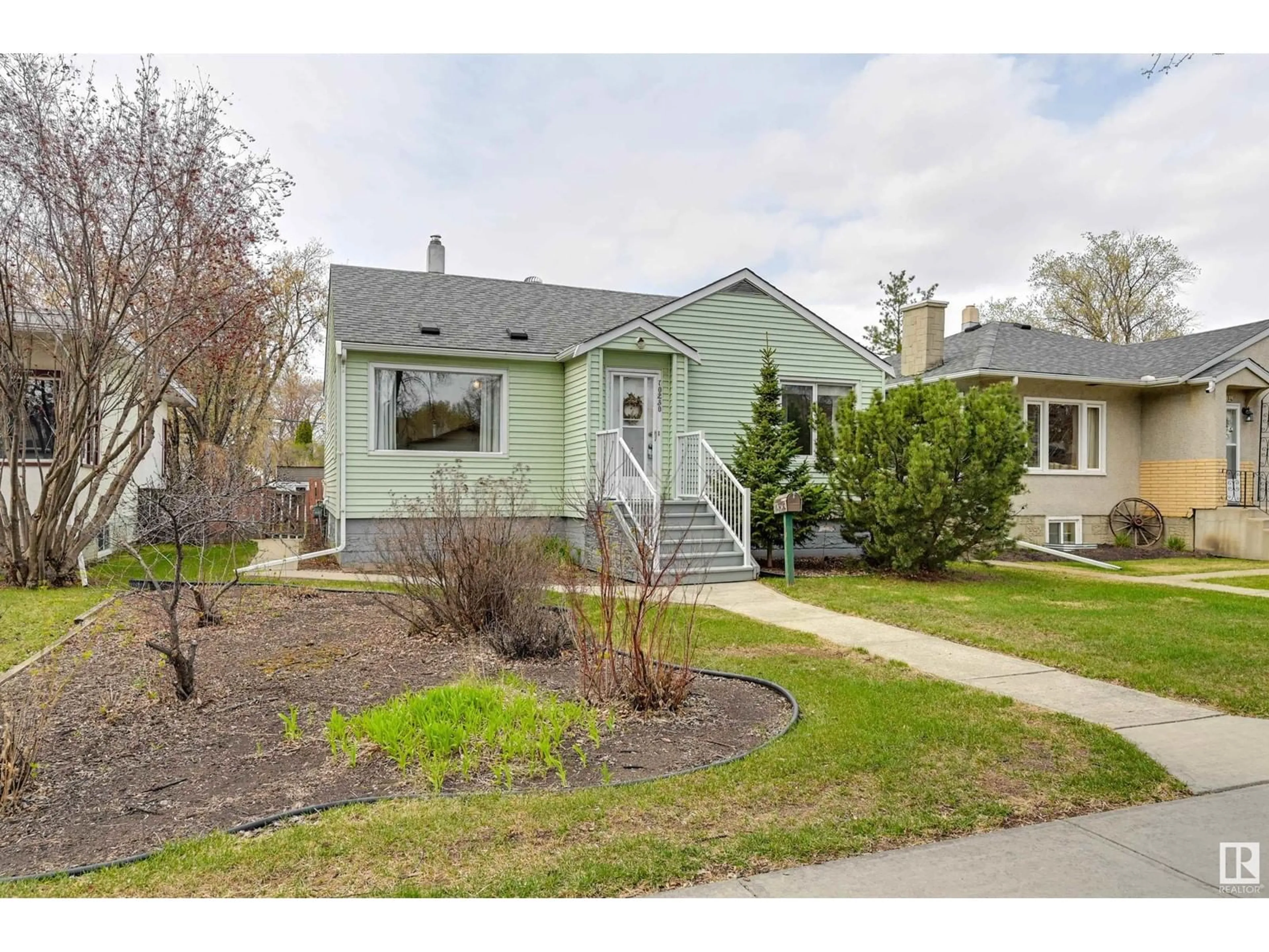 Home with vinyl exterior material, street for 10230 147 ST, Edmonton Alberta T5N3B9