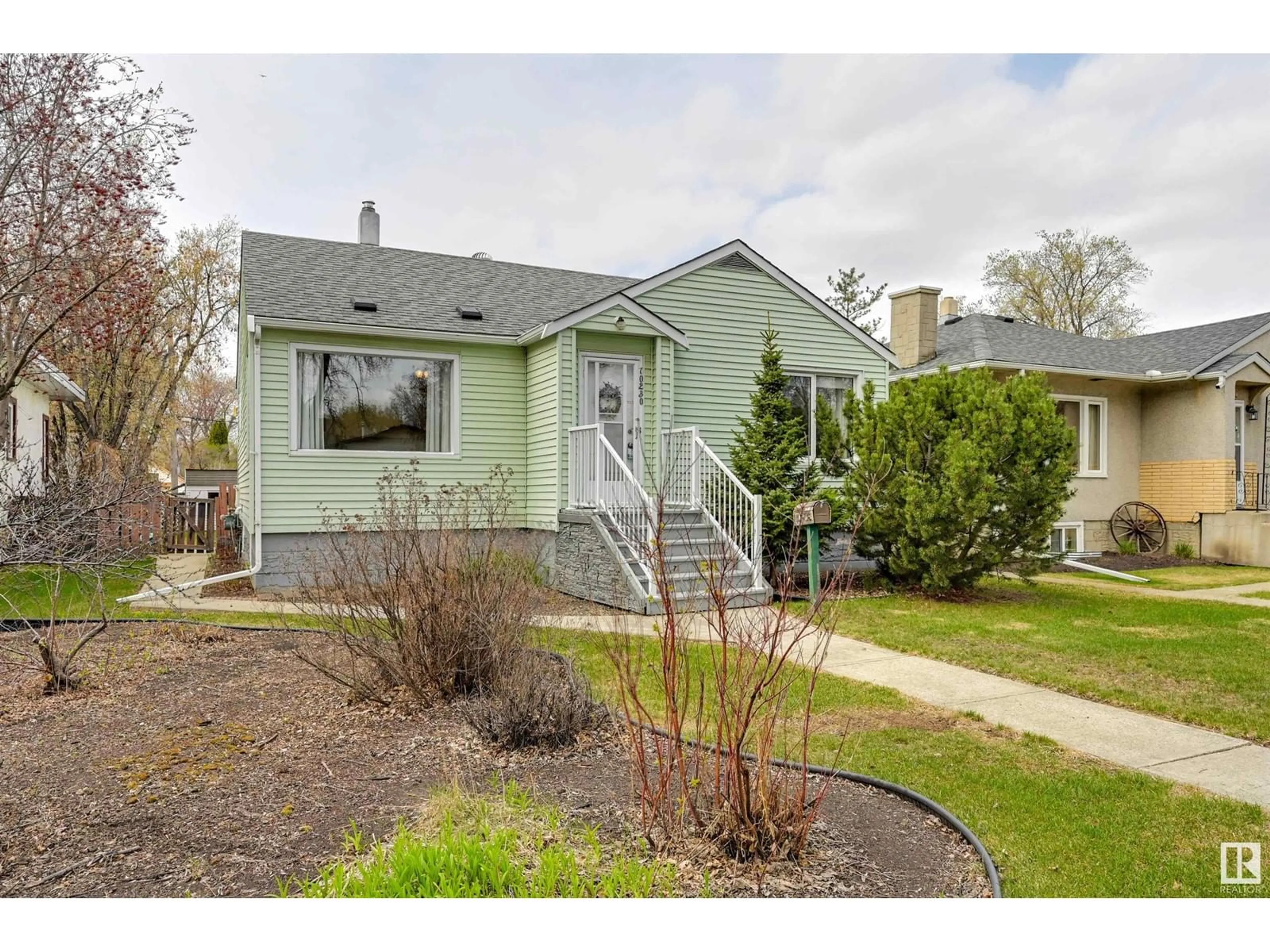 Home with vinyl exterior material, street for 10230 147 ST, Edmonton Alberta T5N3B9