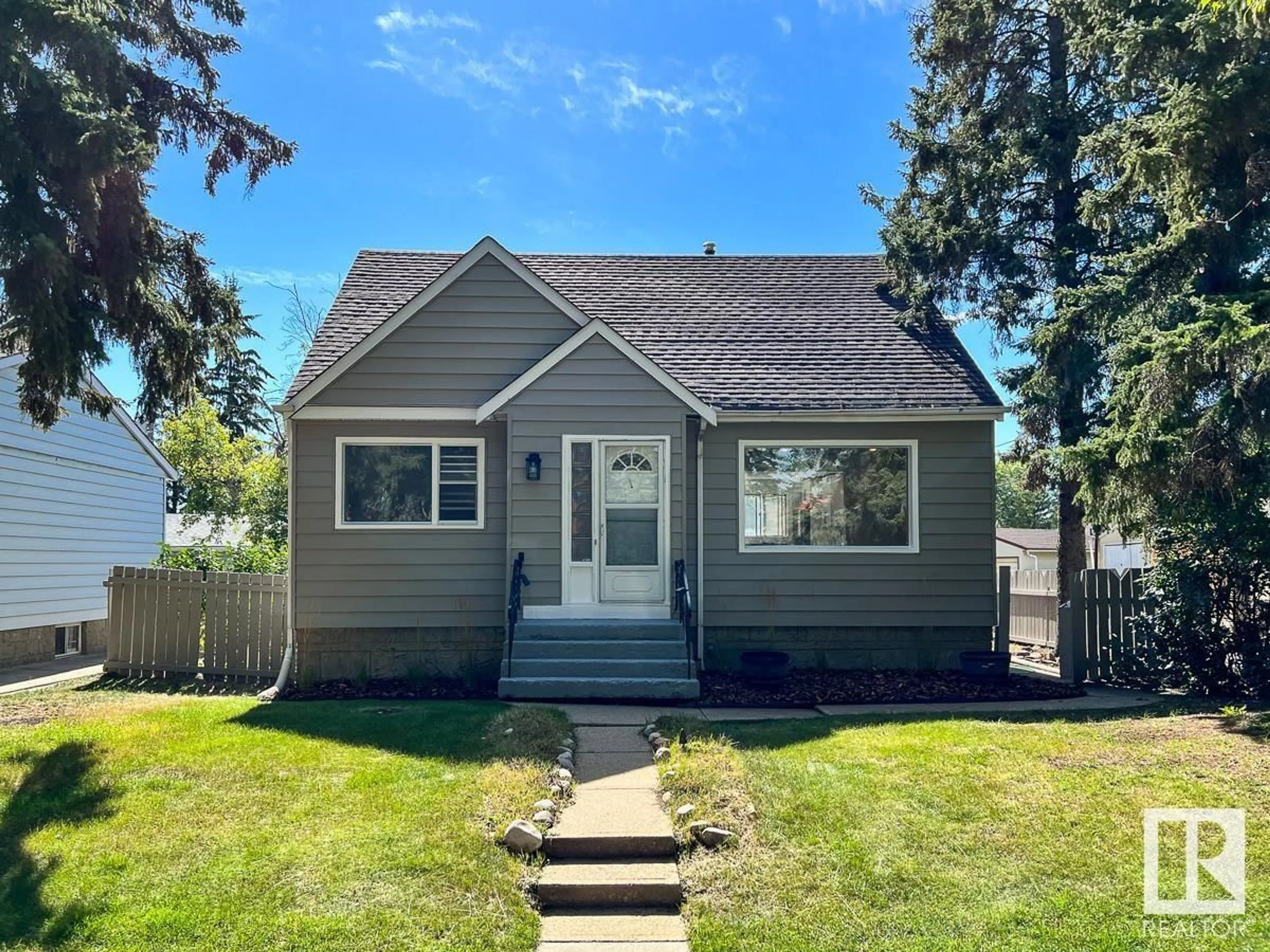 Home with vinyl exterior material, street for 13131 124 AV, Edmonton Alberta T5L2Z9
