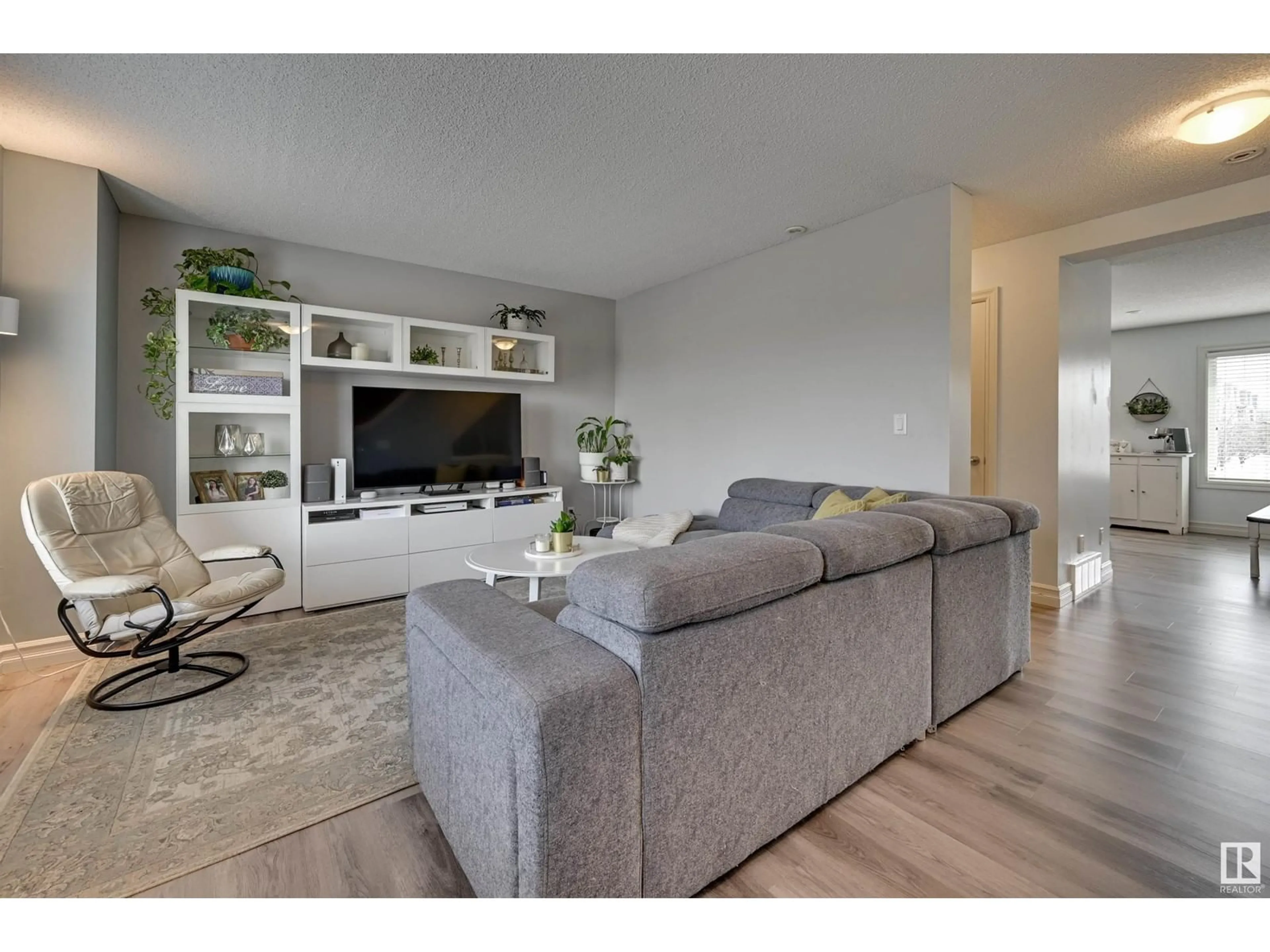 Living room with furniture, wood/laminate floor for #116 - 3625 144 AV, Edmonton Alberta T5Y0T3