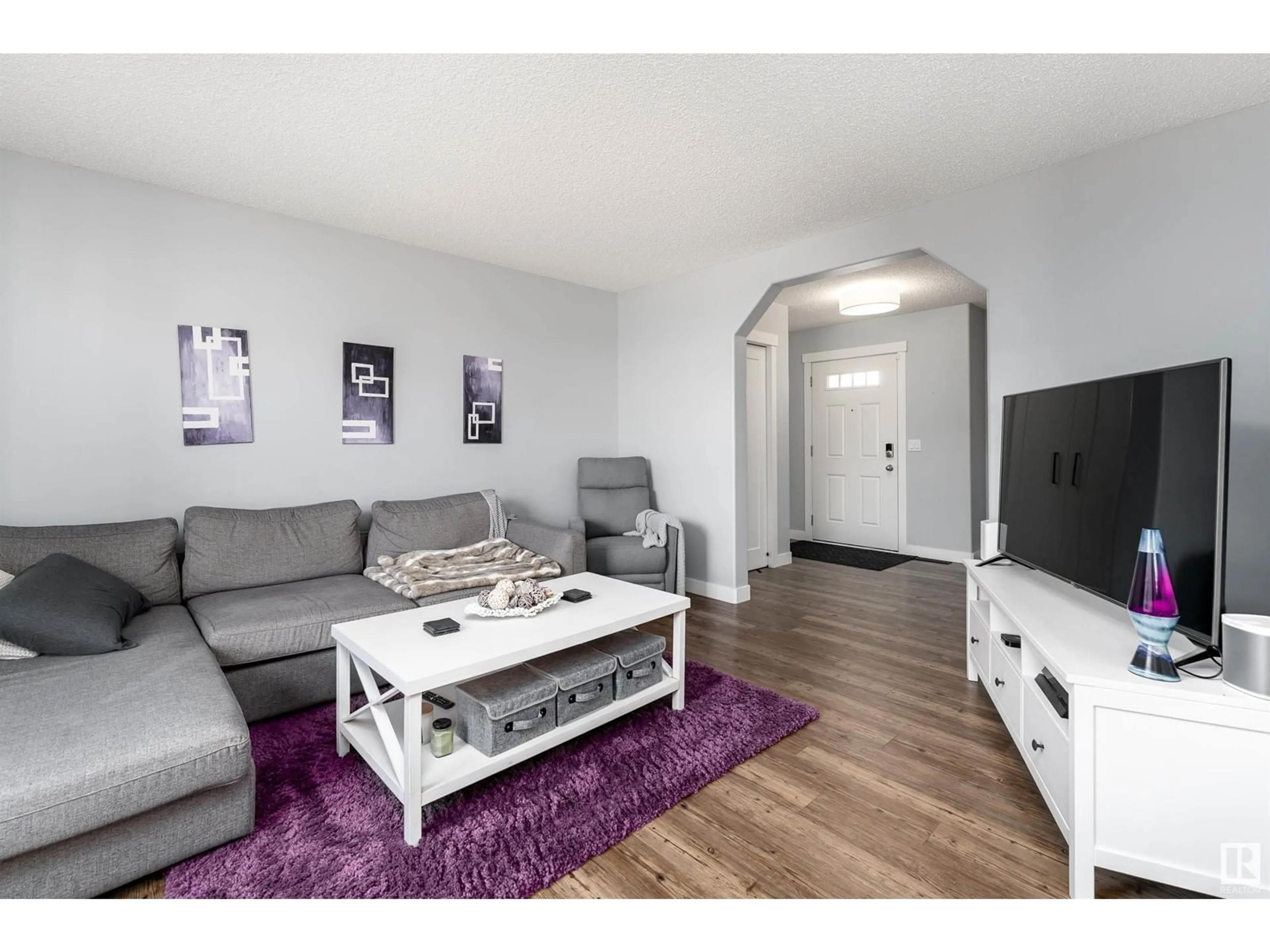 Living room with furniture, wood/laminate floor for 212 ASCOTT CR, Sherwood Park Alberta T8H0A6