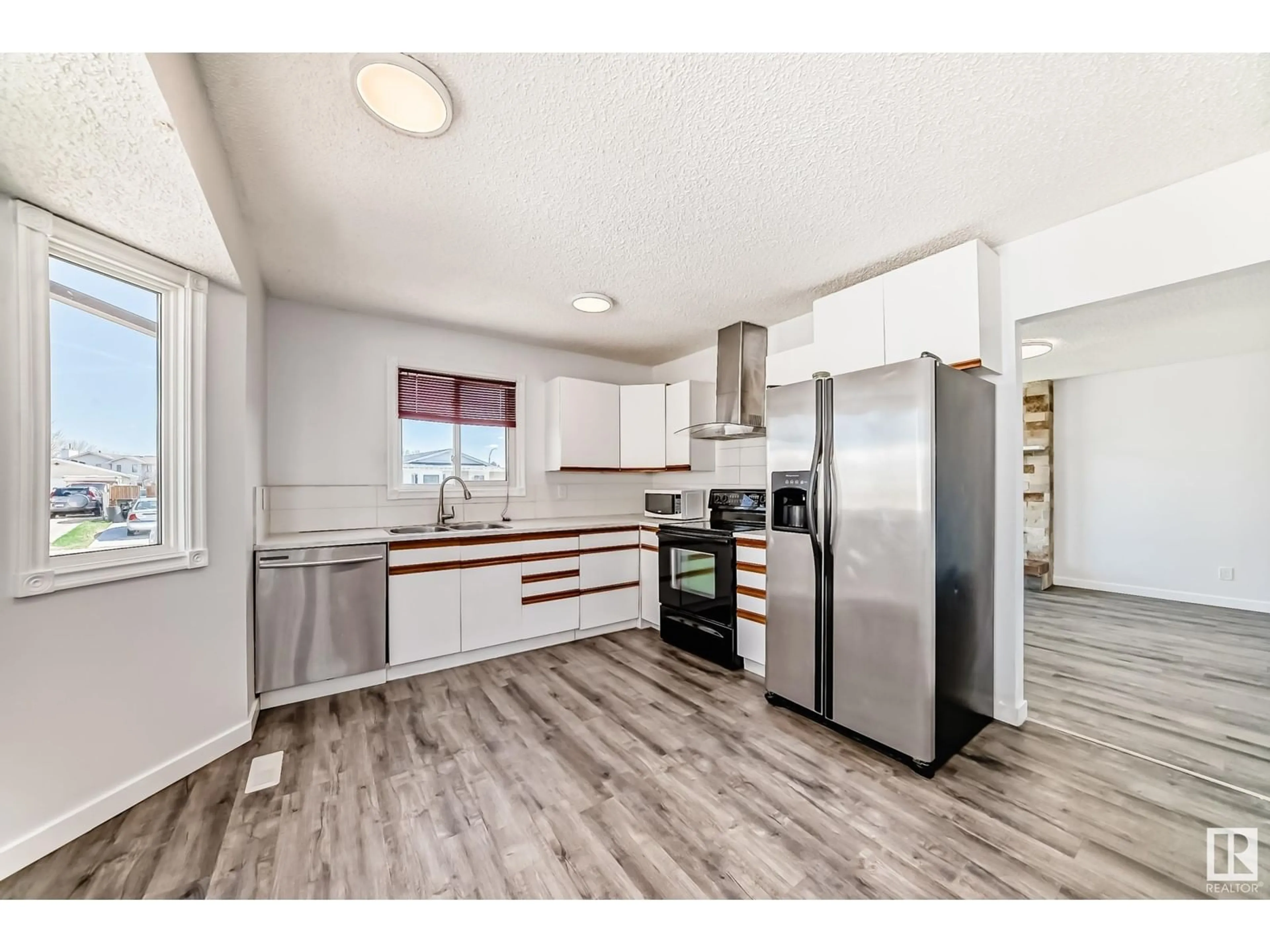 Open concept kitchen, wood/laminate floor for 3308 44A ST, Edmonton Alberta T6L4W9