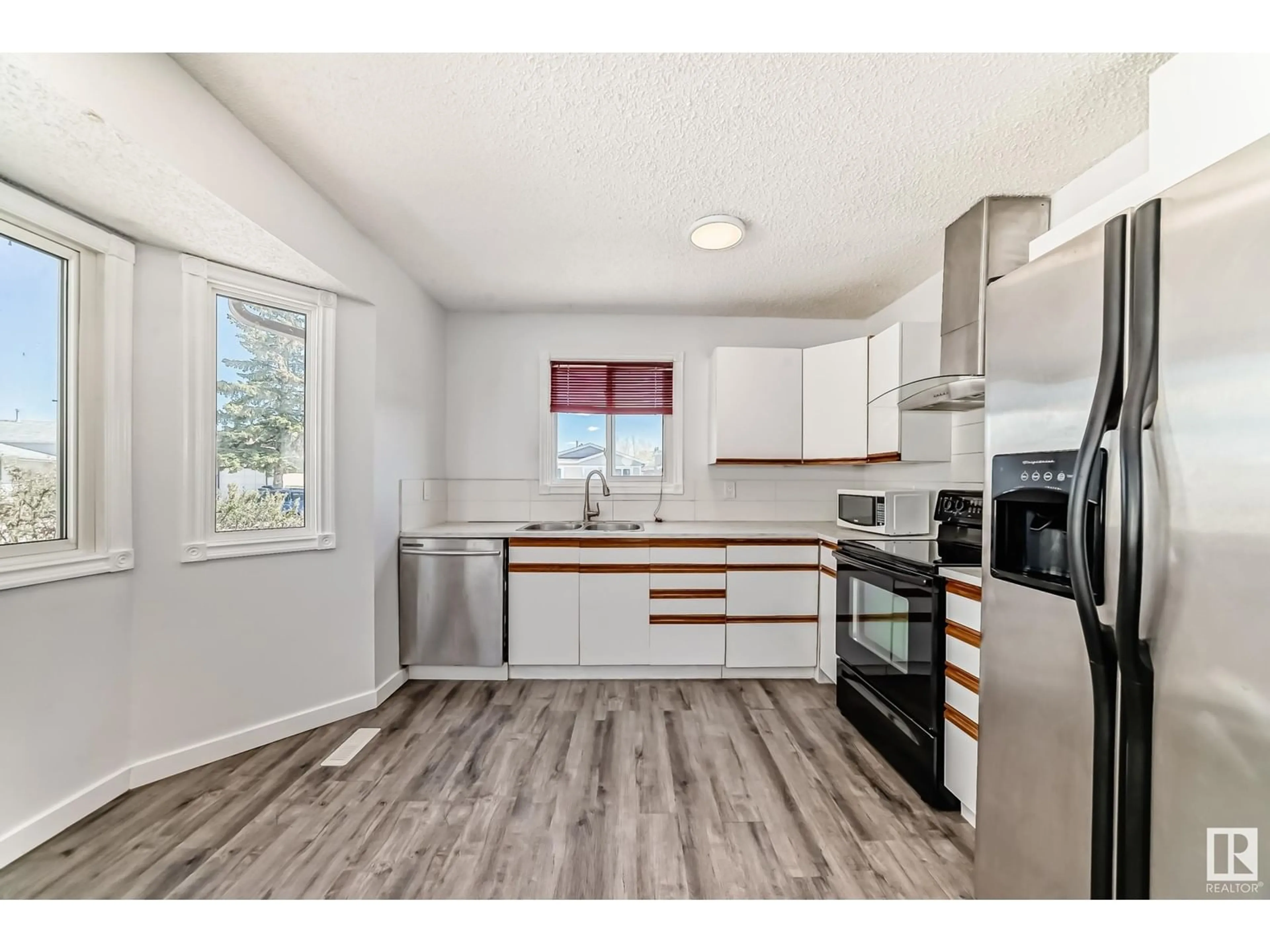 Open concept kitchen, wood/laminate floor for 3308 44A ST, Edmonton Alberta T6L4W9