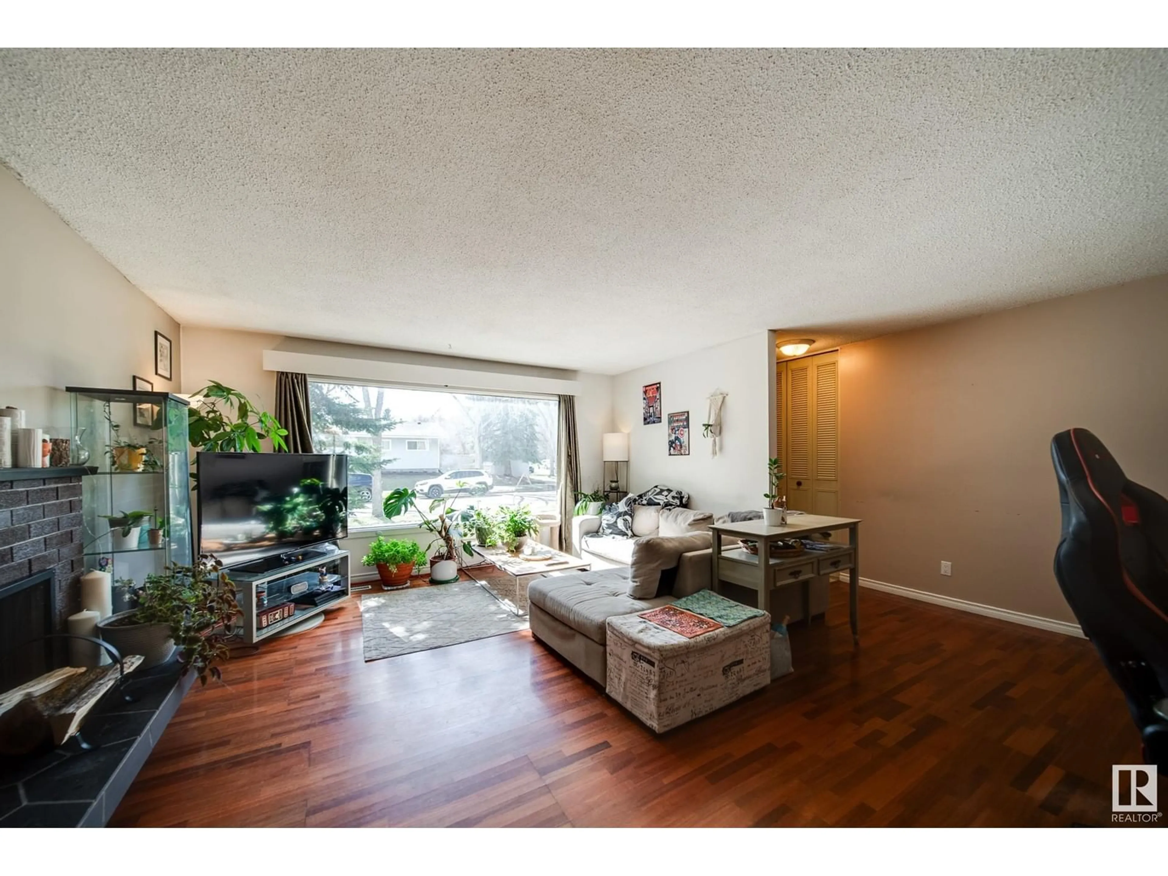 Living room with furniture, wood/laminate floor for 9621 89B ST, Fort Saskatchewan Alberta T8L1J8