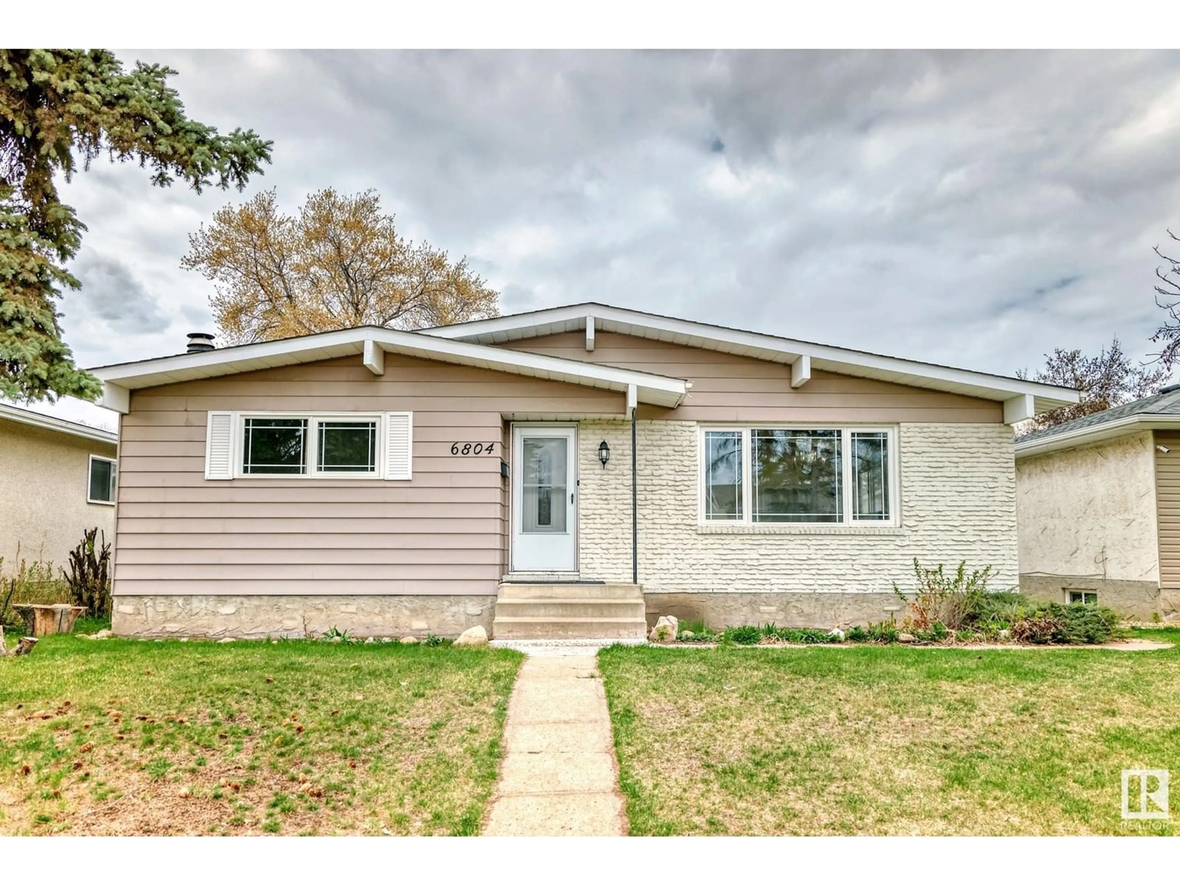 Home with vinyl exterior material, street for 6804 32 AV, Edmonton Alberta T6K1P2