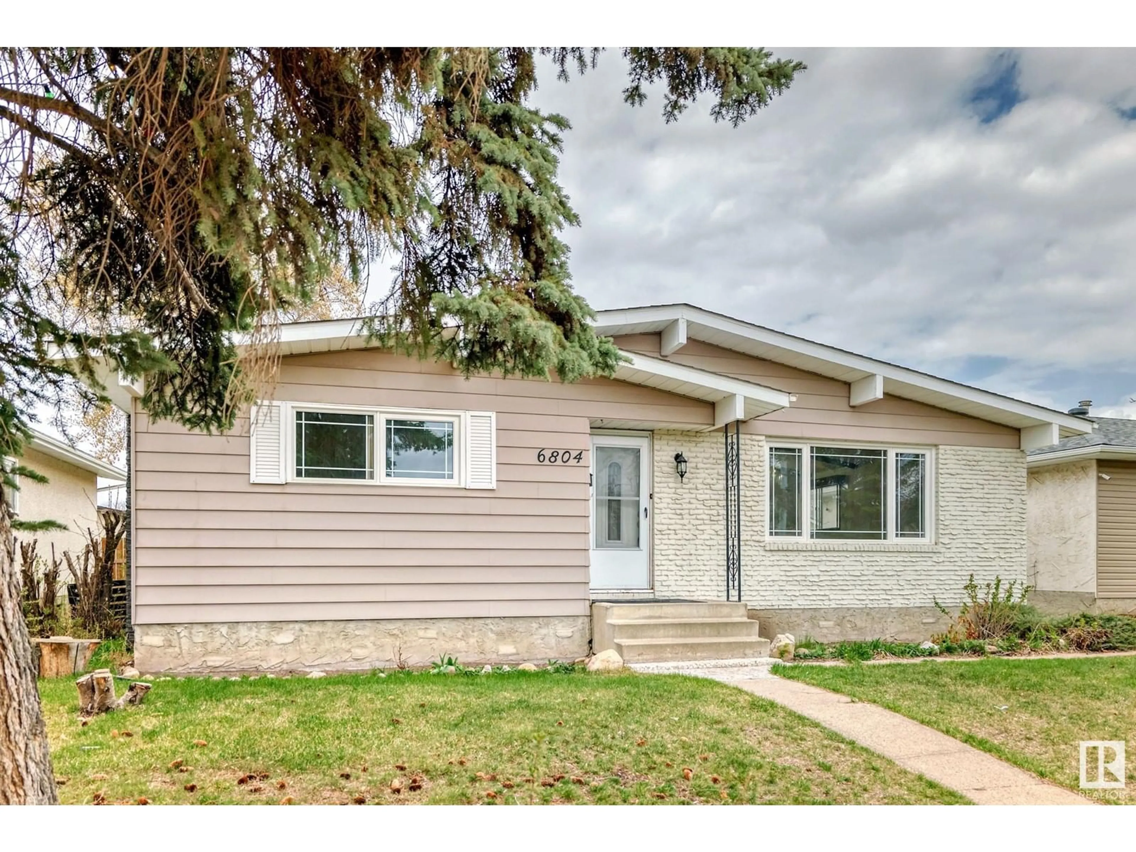 Home with vinyl exterior material, street for 6804 32 AV, Edmonton Alberta T6K1P2