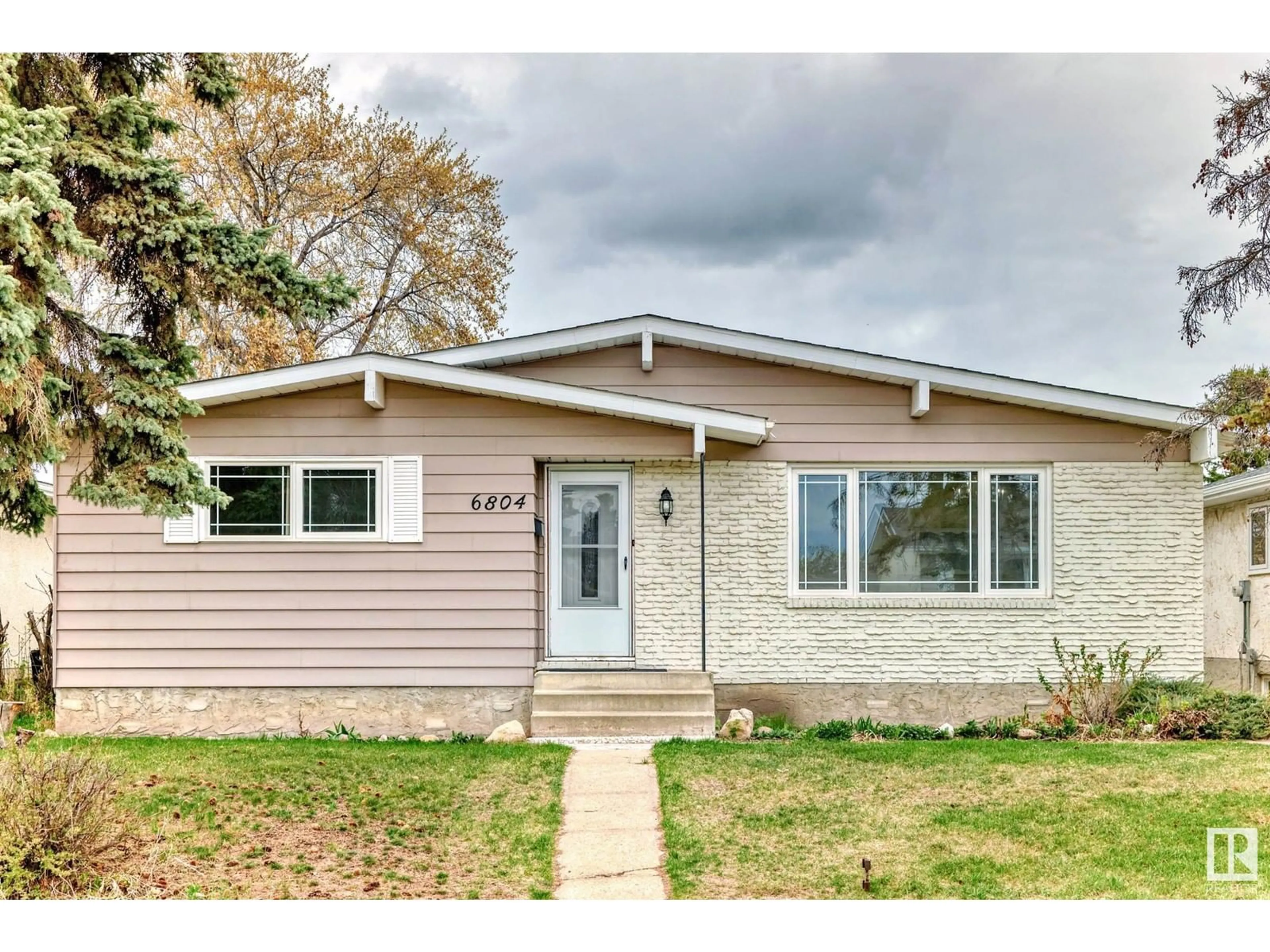 Home with vinyl exterior material, street for 6804 32 AV, Edmonton Alberta T6K1P2