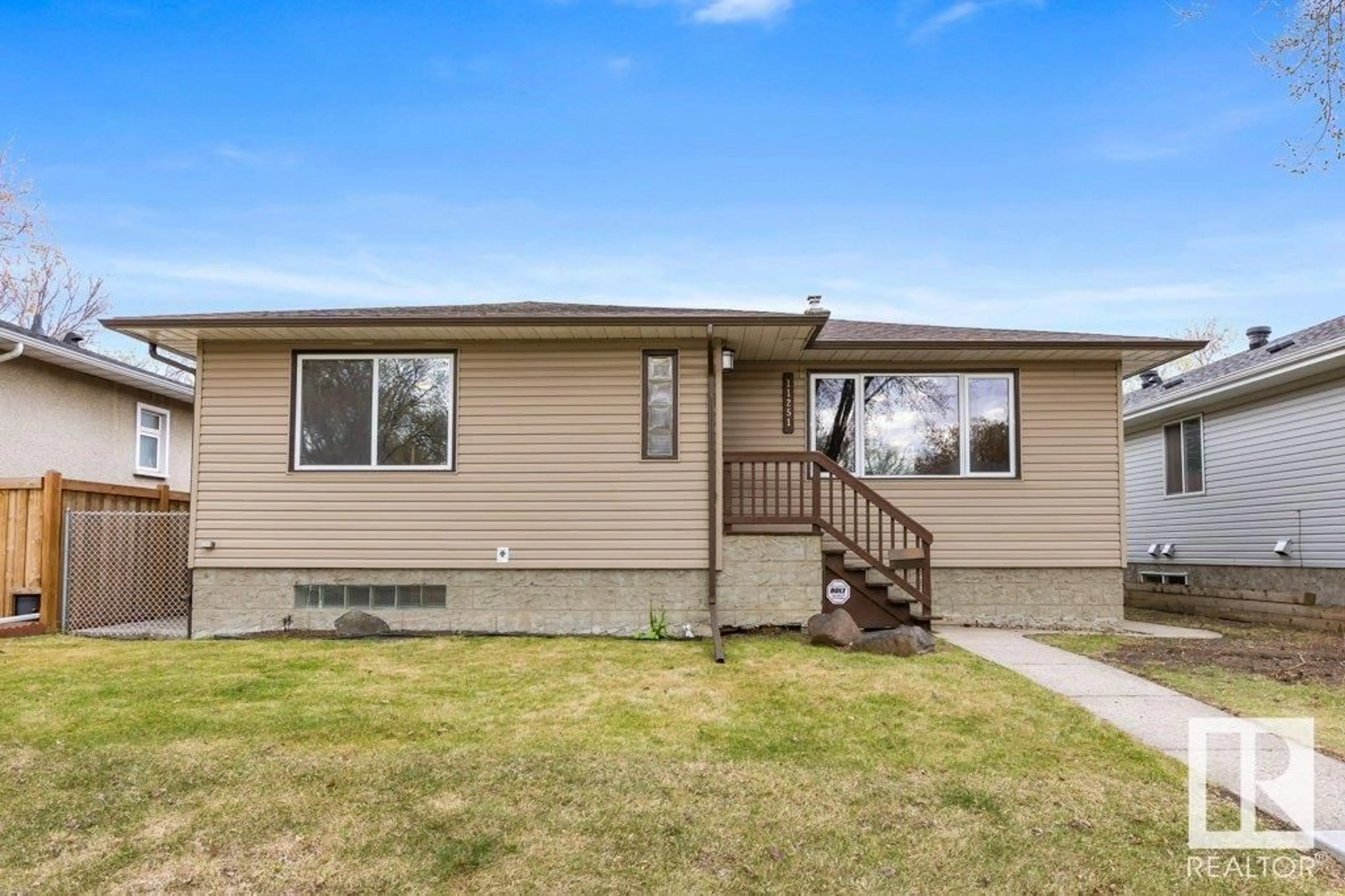 Home with vinyl exterior material, street for 11251 52 ST, Edmonton Alberta T6L1Z2