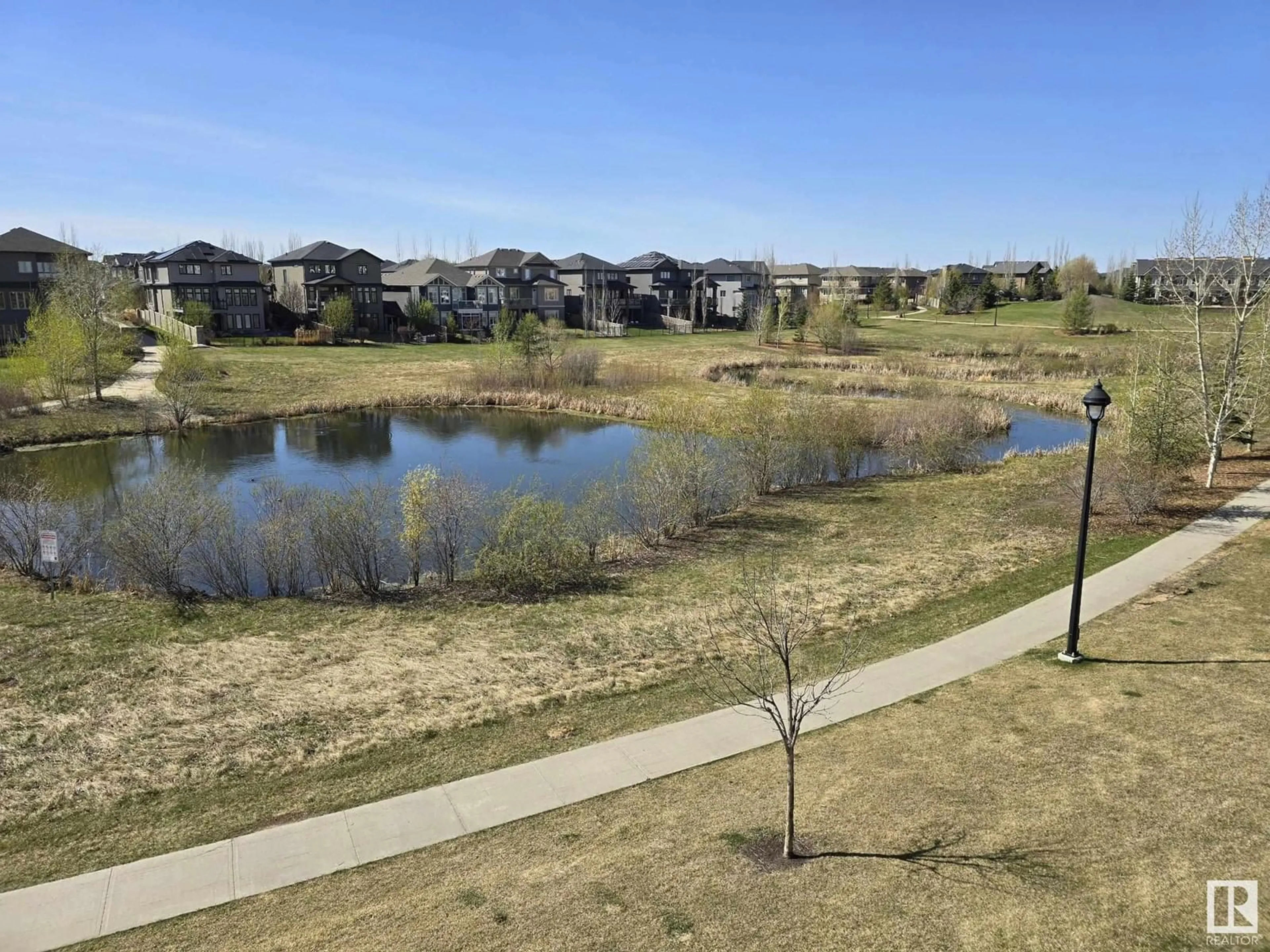 A pic from outside/outdoor area/front of a property/back of a property/a pic from drone, water/lake/river/ocean view for #206 - 1316 WINDERMERE WY, Edmonton Alberta T6W0P1