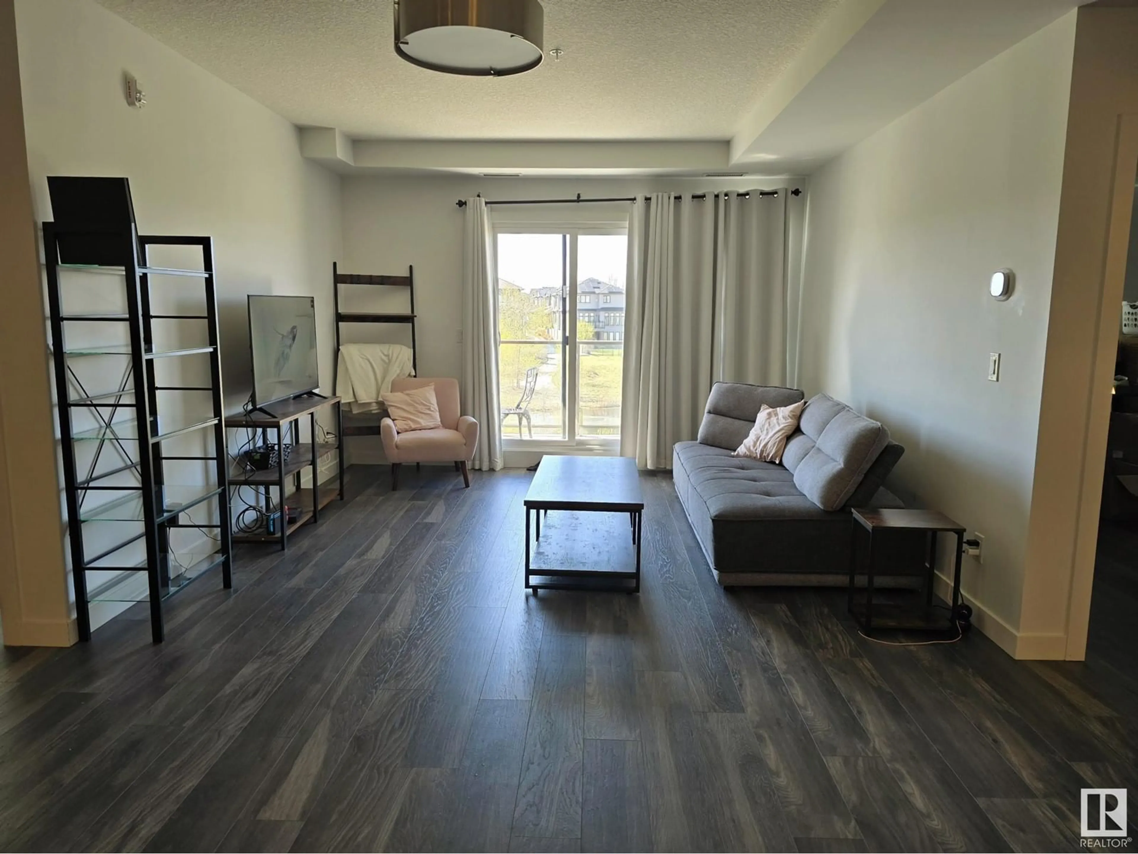 Living room with furniture, wood/laminate floor for #206 - 1316 WINDERMERE WY, Edmonton Alberta T6W0P1