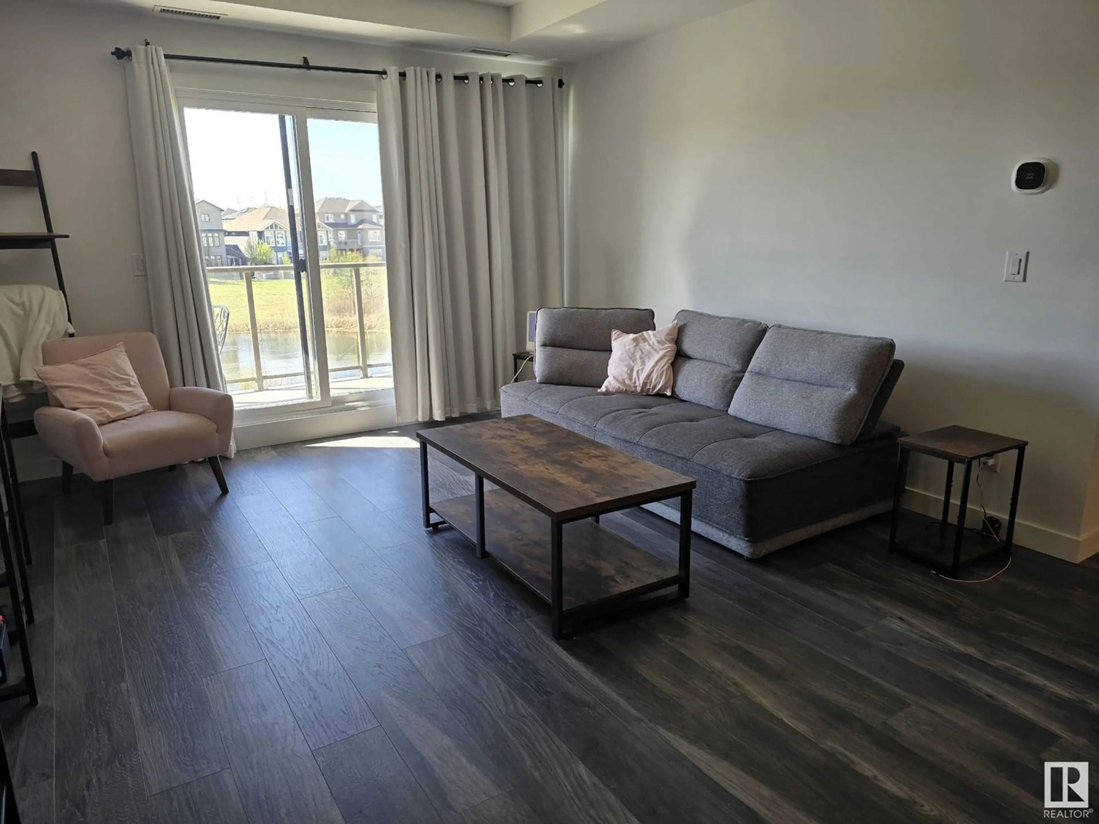 Living room with furniture, wood/laminate floor for #206 - 1316 WINDERMERE WY, Edmonton Alberta T6W0P1