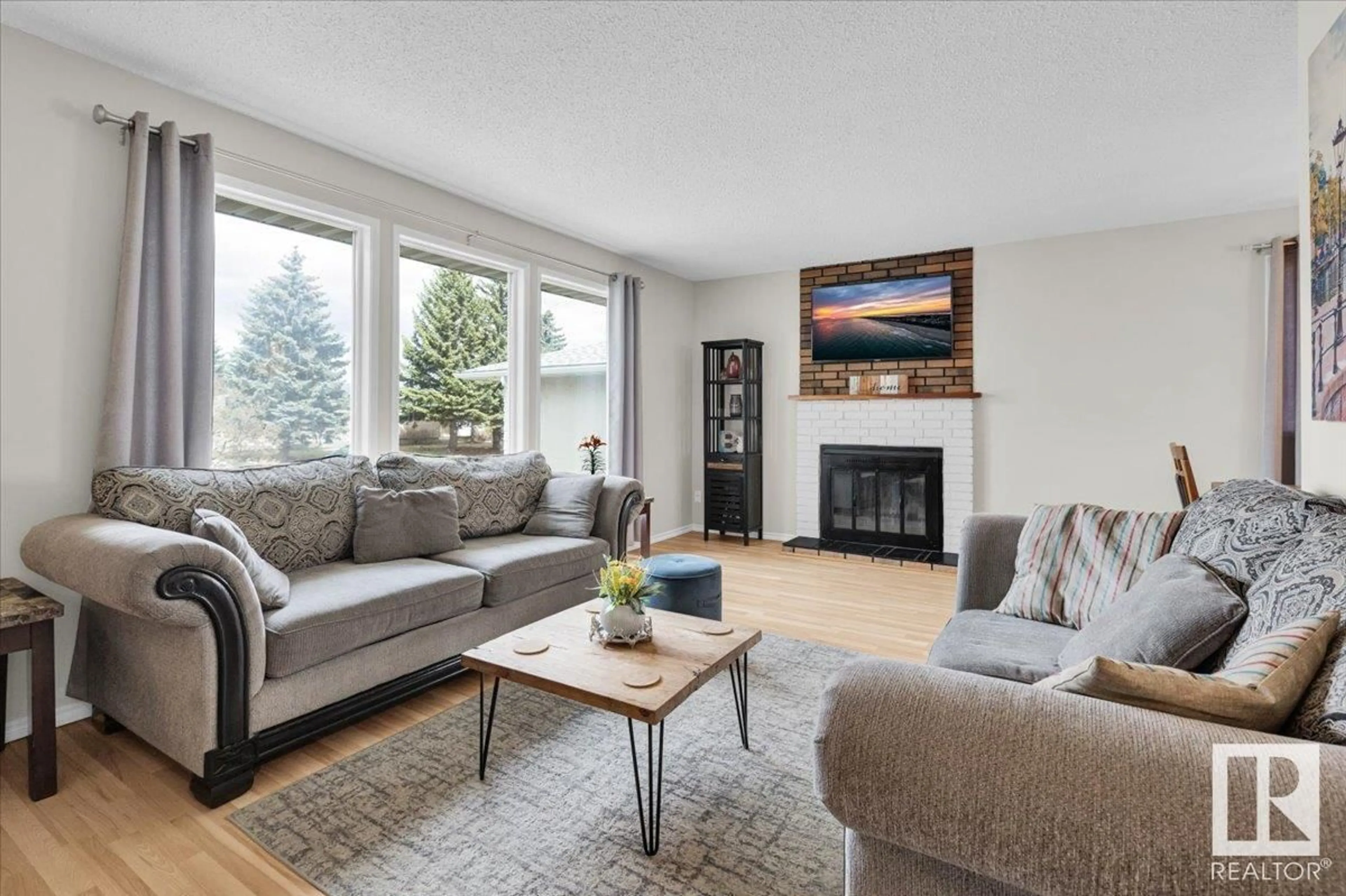Living room with furniture, wood/laminate floor for 11719 158 AV, Edmonton Alberta T5X2K3
